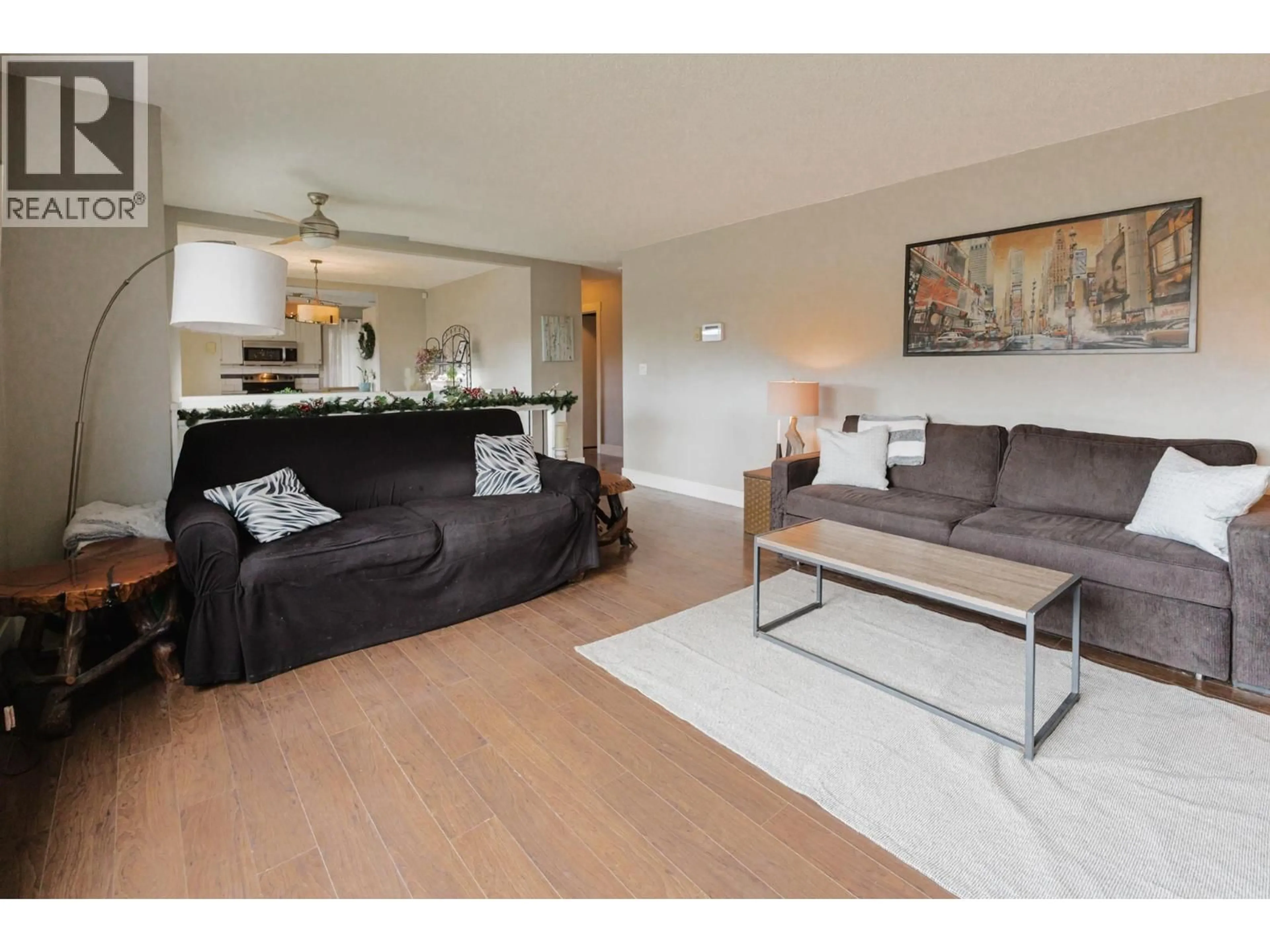 Living room with furniture, wood/laminate floor for 2126 VERDE VISTA ROAD, Kelowna British Columbia V1P1G5