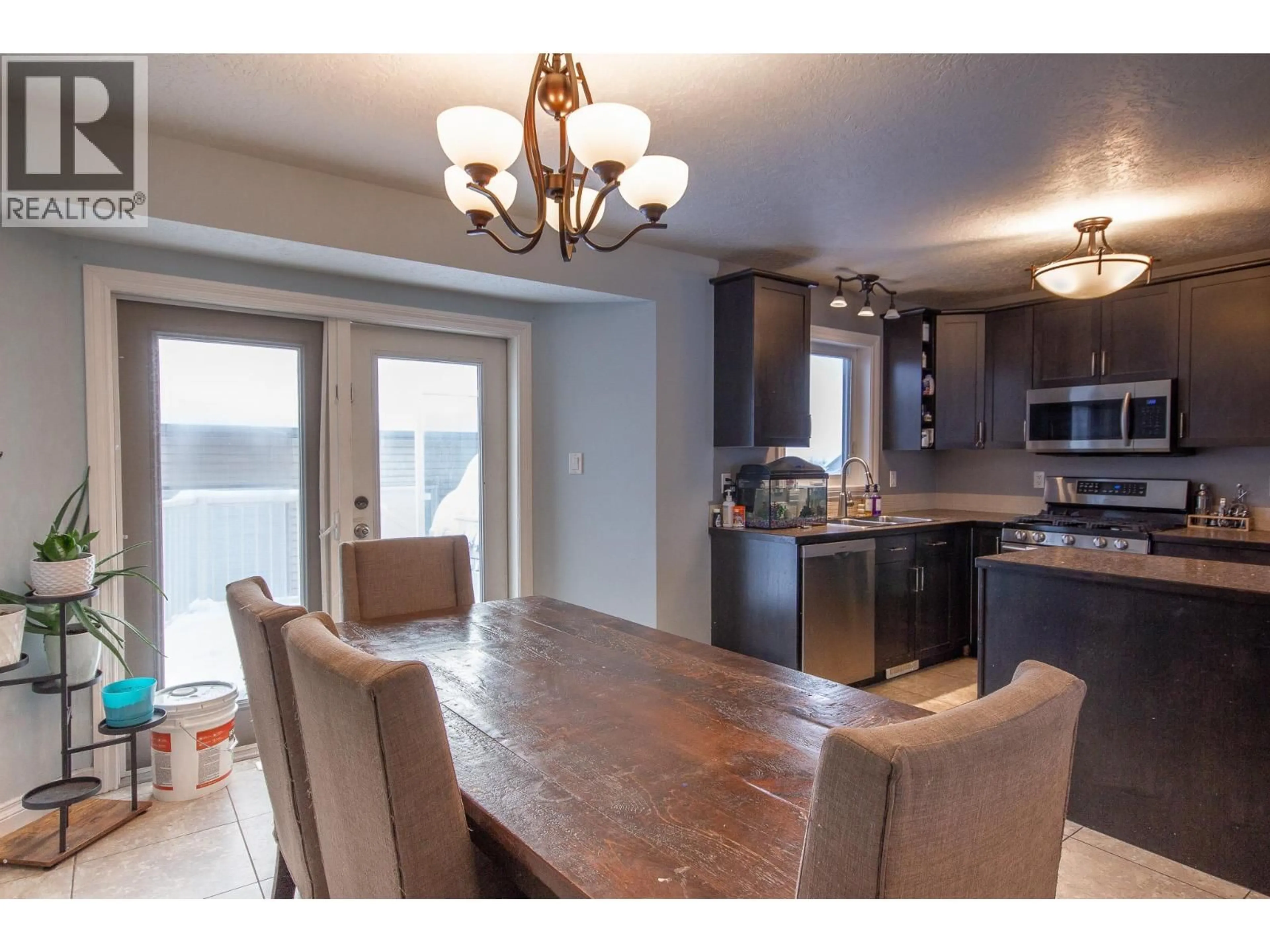 Open concept kitchen, wood/laminate floor for 1717 87 AVENUE, Dawson Creek British Columbia V1G0B2