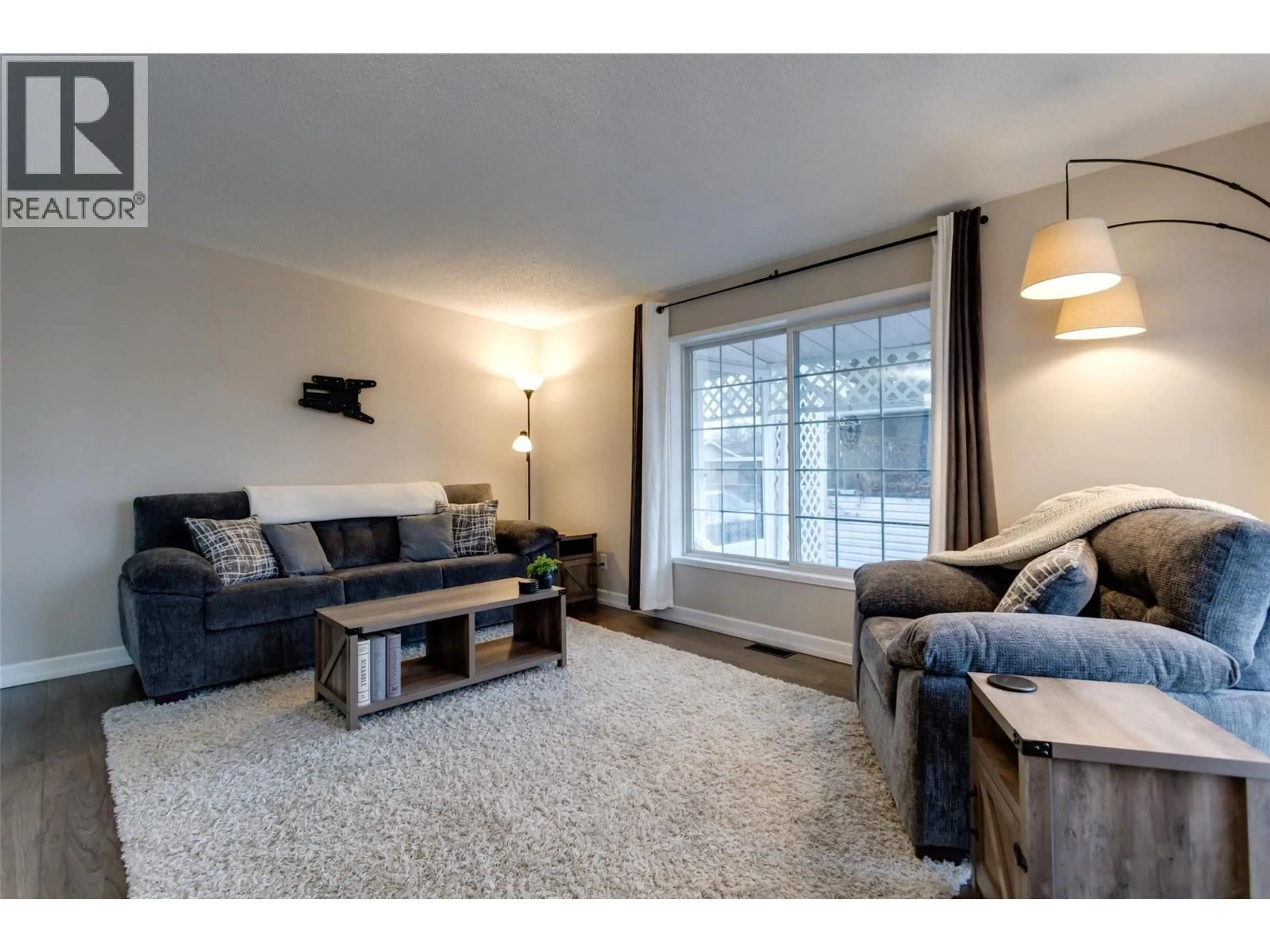 Living room with furniture, wood/laminate floor for 138 - 2005 BOUCHERIE ROAD, West Kelowna British Columbia V4T1R4