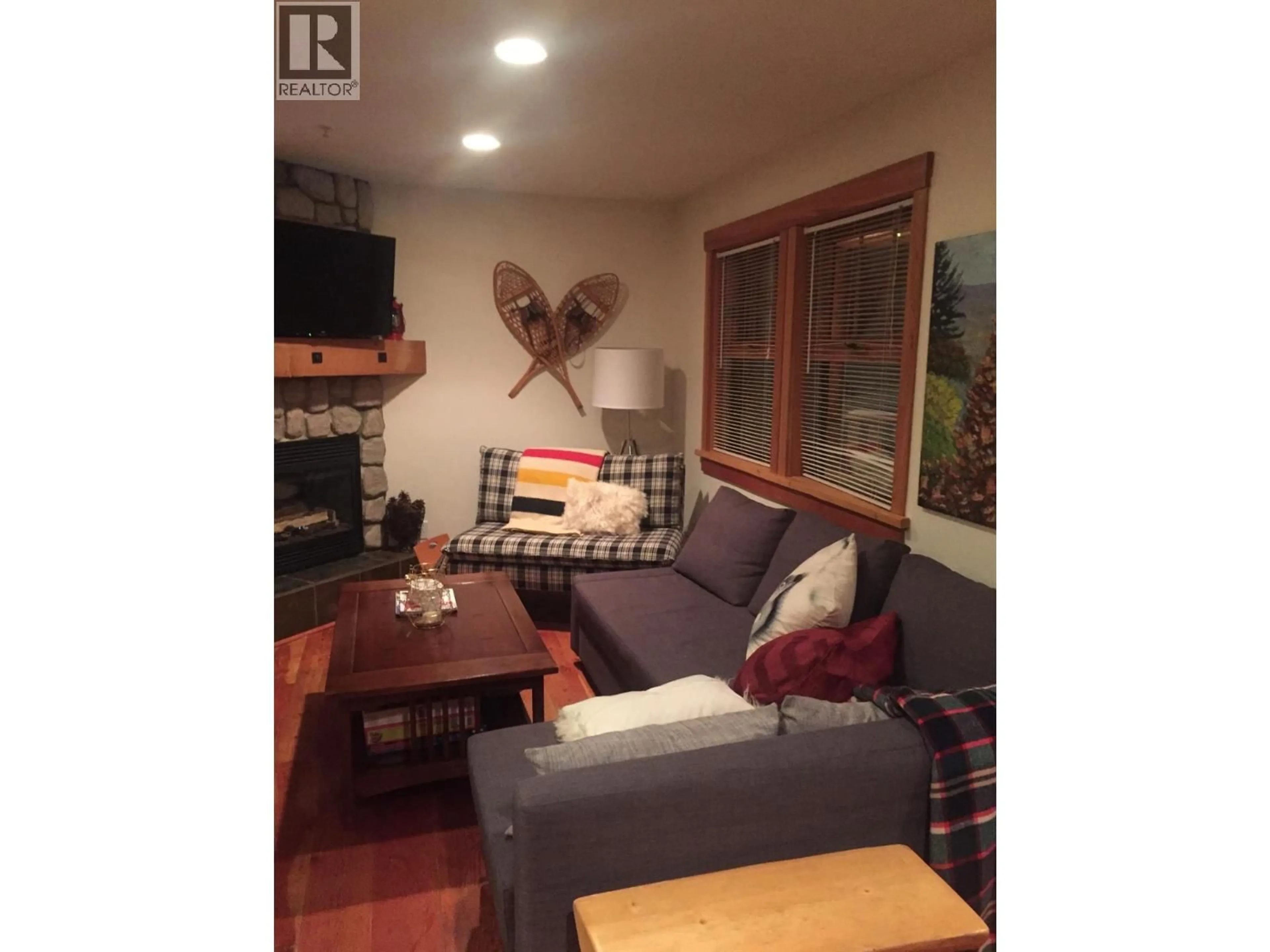 Living room with furniture, wood/laminate floor for 4809 C SNOW PINES ROAD, Big White British Columbia V1P1P3