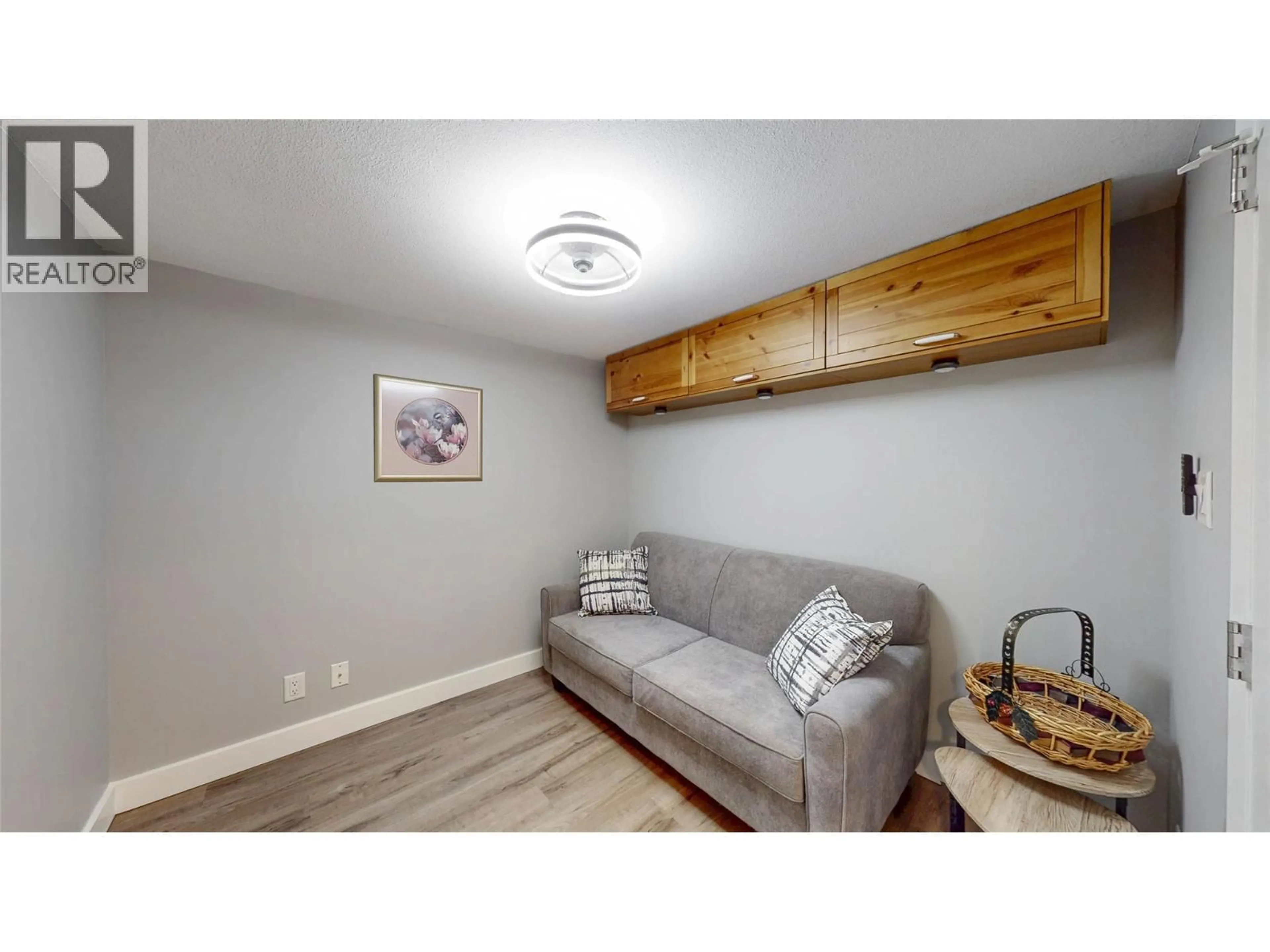 Living room with furniture, wood/laminate floor for 308 - 7600 COTTONWOOD DRIVE, Osoyoos British Columbia V0H1V3