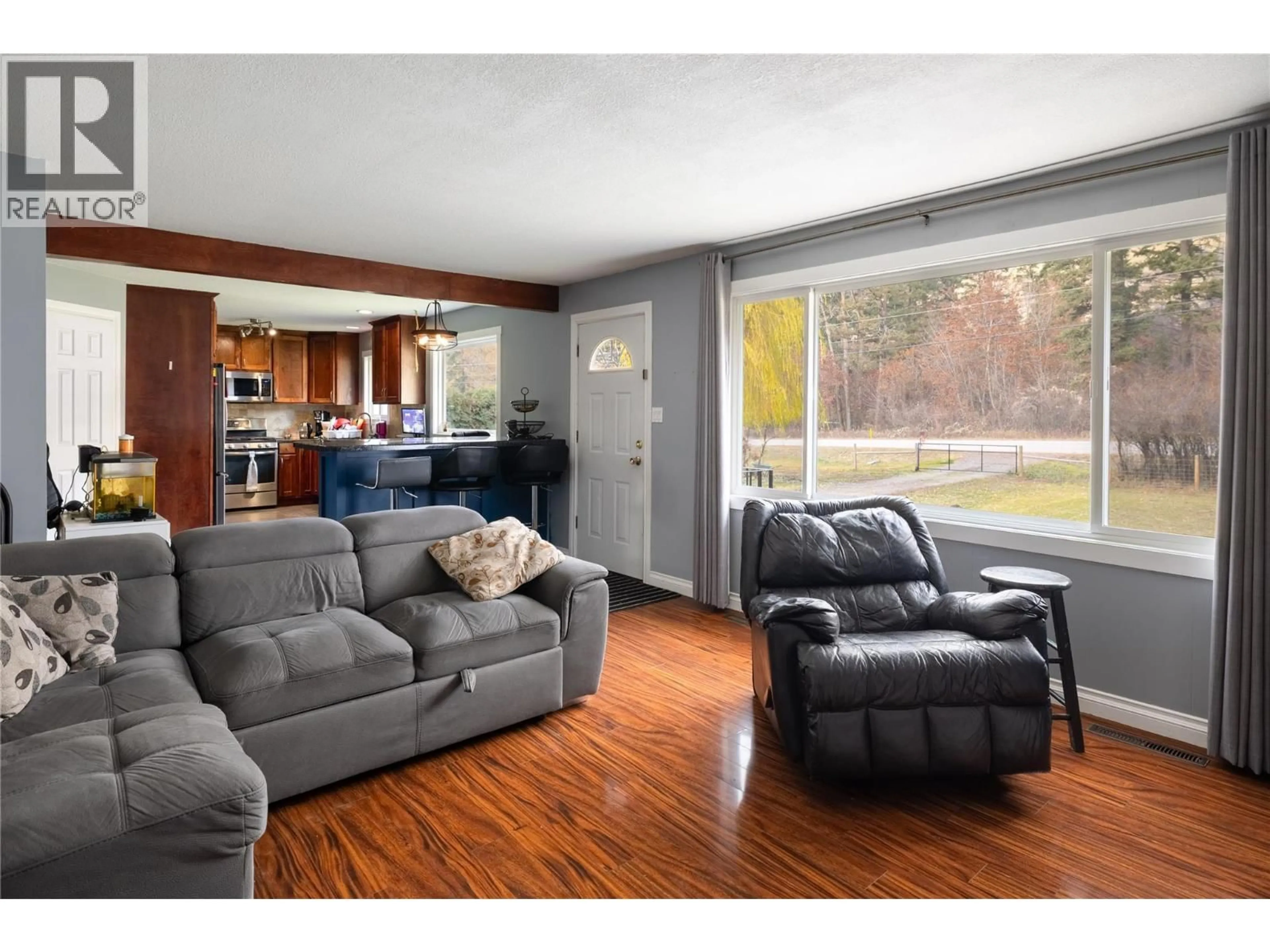 Living room with furniture, wood/laminate floor for 5712 6 HIGHWAY, Vernon British Columbia V1B3E1