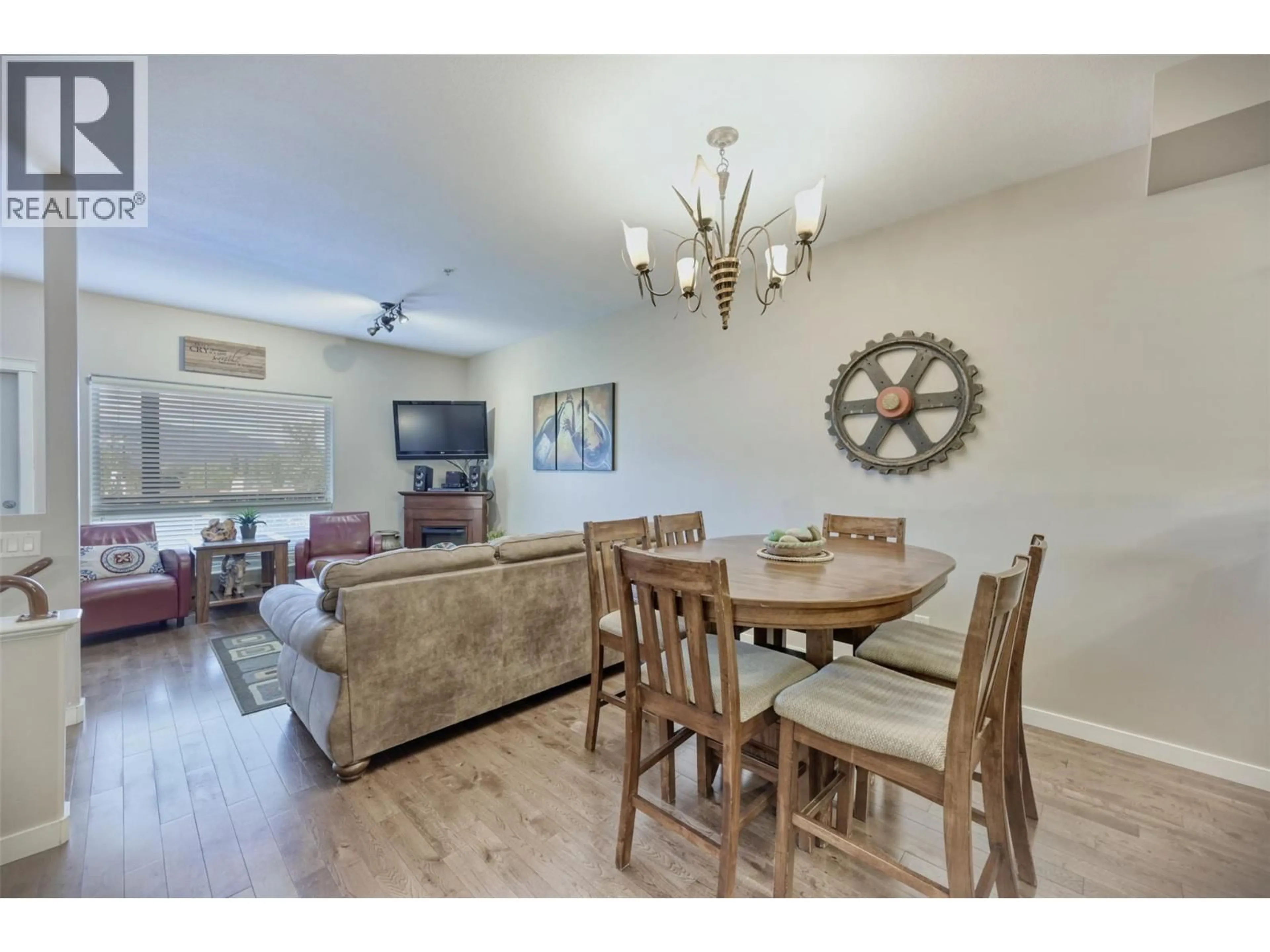 Living room with furniture, wood/laminate floor for 109 - 4300 44TH AVENUE, Osoyoos British Columbia V0H1V6