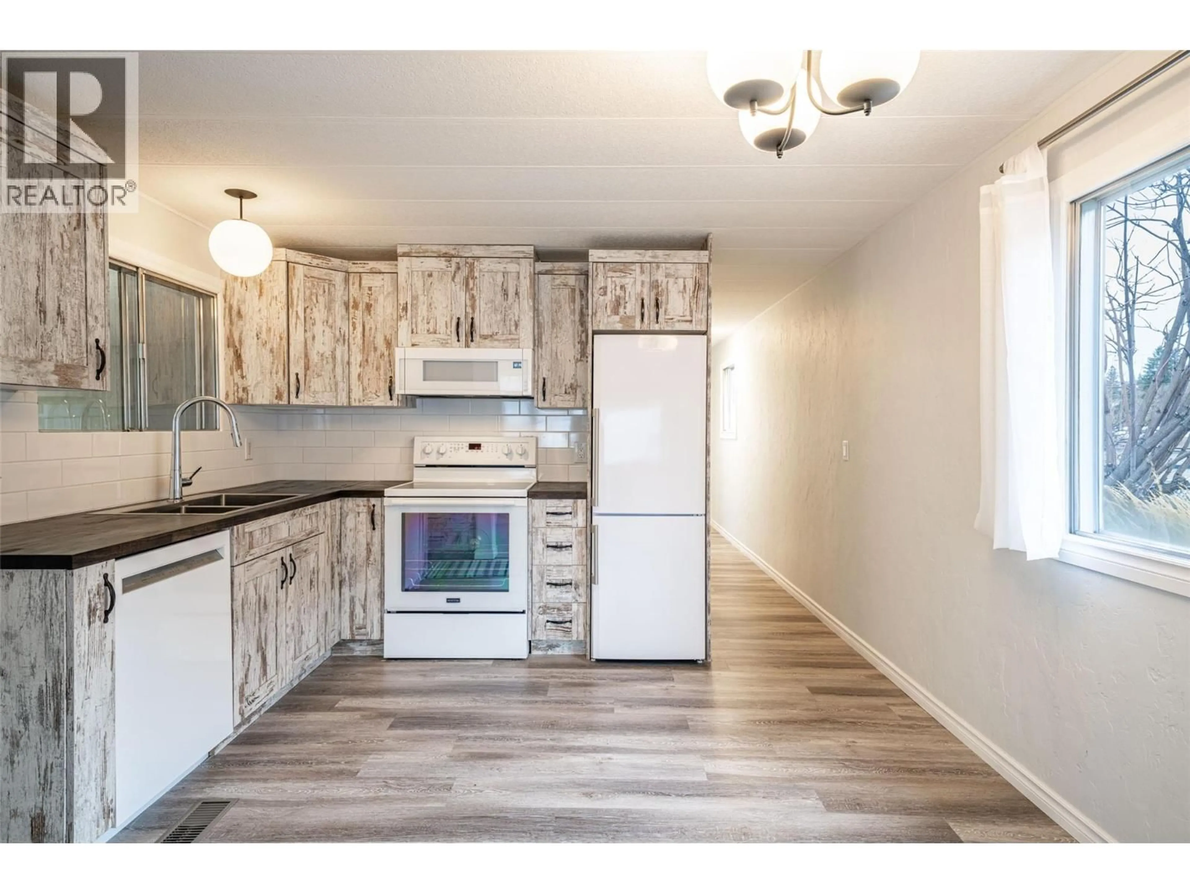 Open concept kitchen, wood/laminate floor for E14 - 4505 MCLEAN CREEK ROAD, Okanagan Falls British Columbia V0H1R1