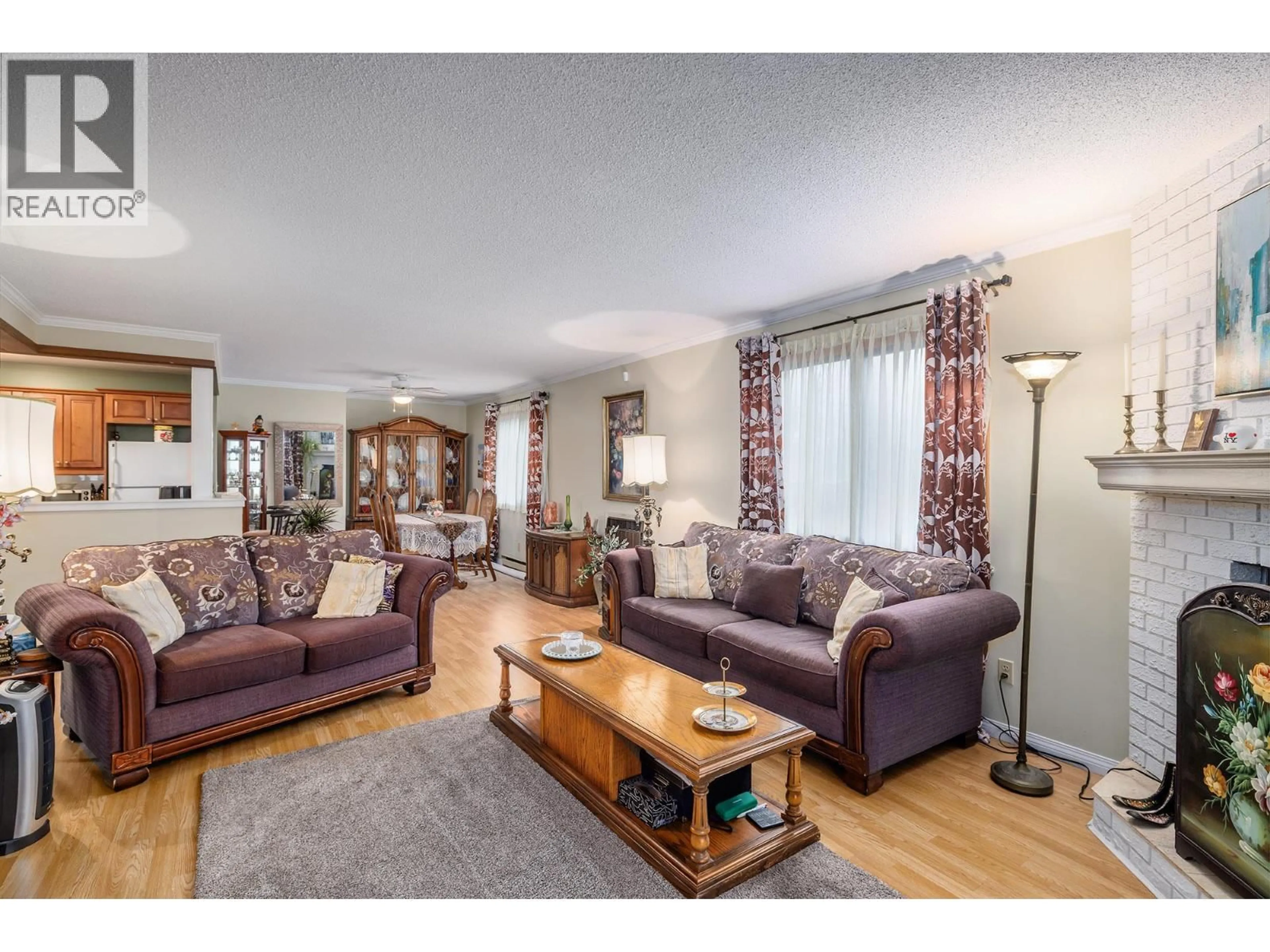 Living room with furniture, wood/laminate floor for 214 - 1035 BERNARD AVENUE, Kelowna British Columbia V1Y6P7