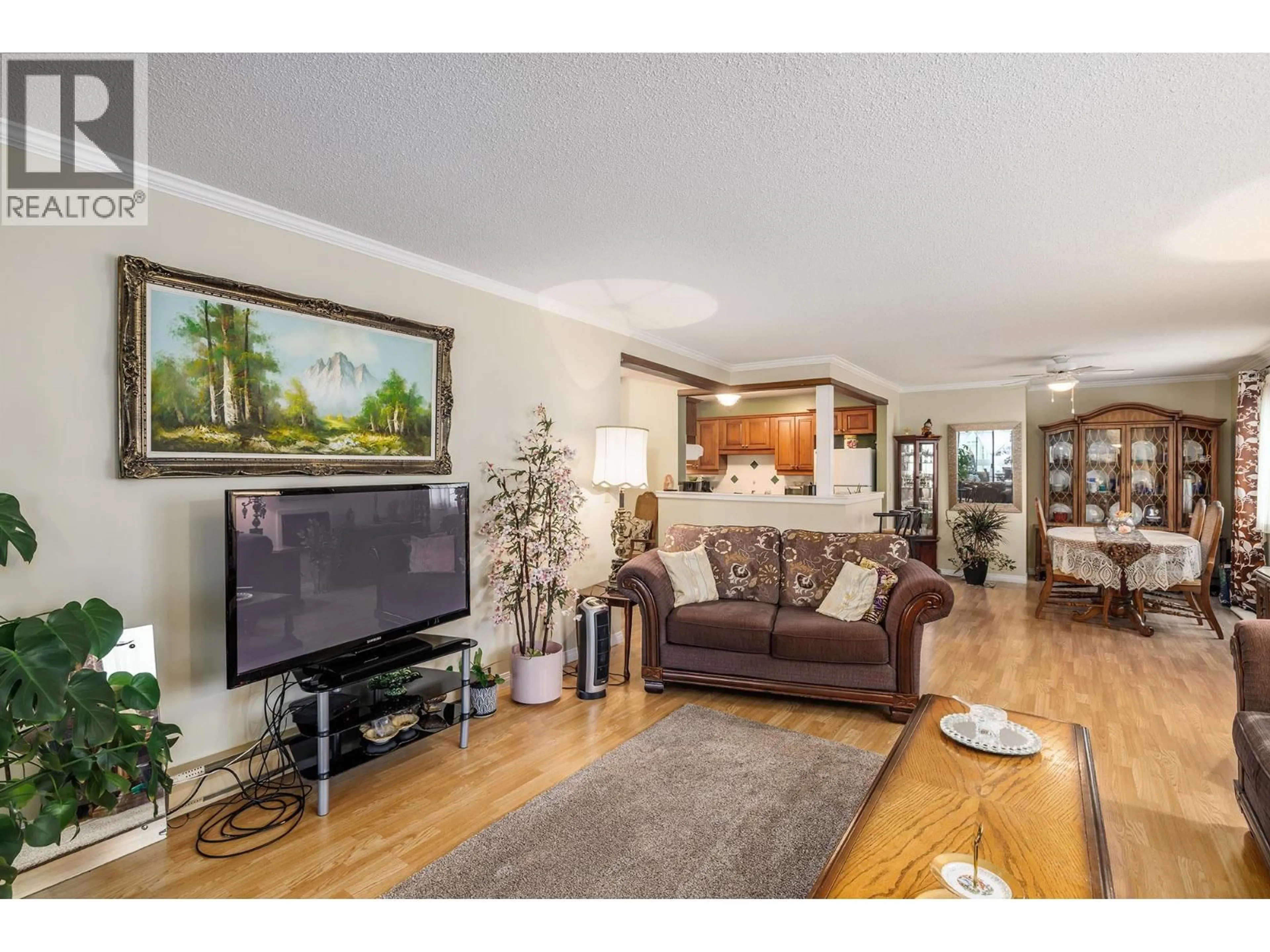 Living room with furniture, wood/laminate floor for 214 - 1035 BERNARD AVENUE, Kelowna British Columbia V1Y6P7