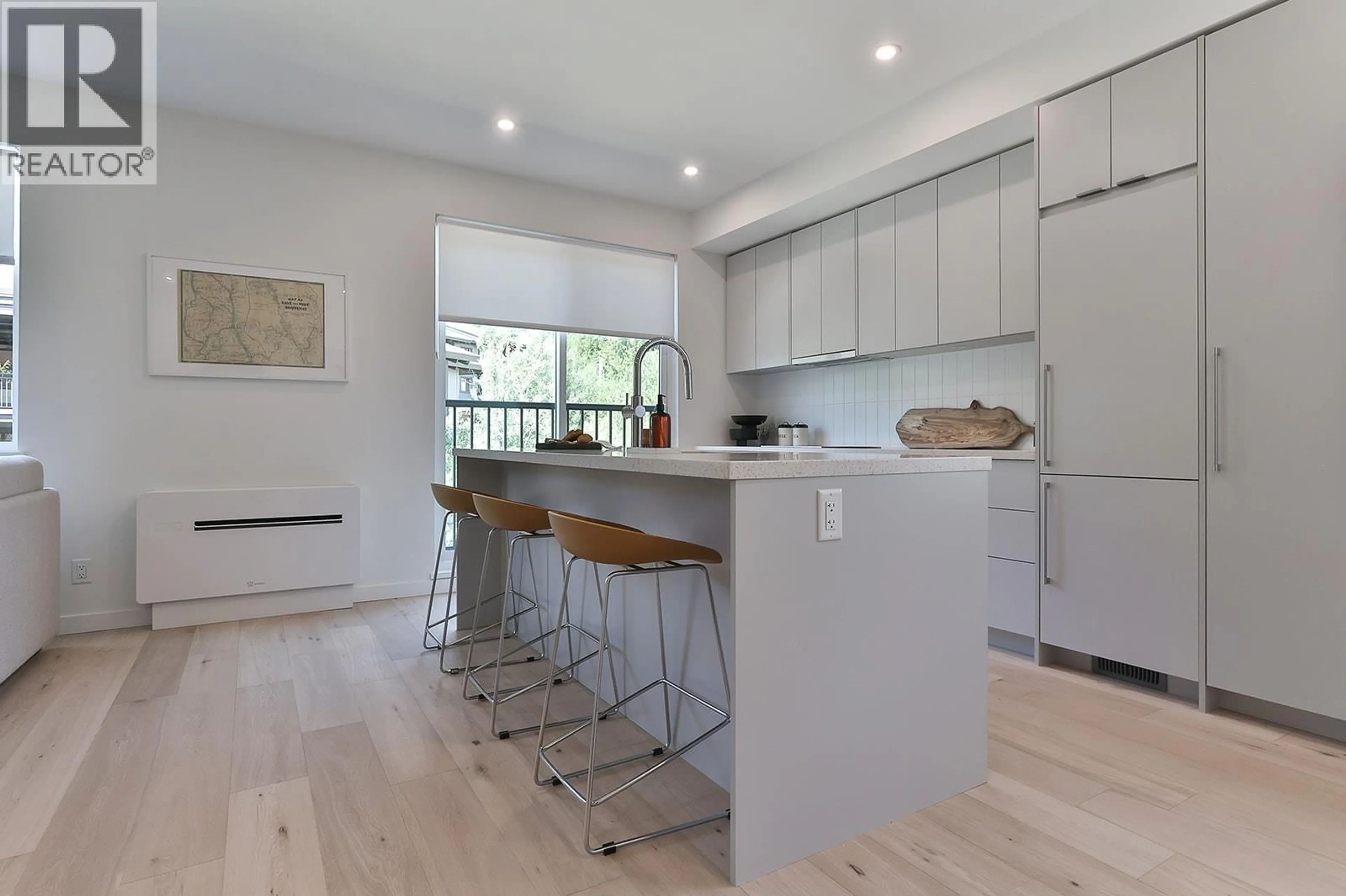 Open concept kitchen, wood/laminate floor for 111 - 4280 RED MOUNTAIN ROAD, Rossland British Columbia V0G1Y0