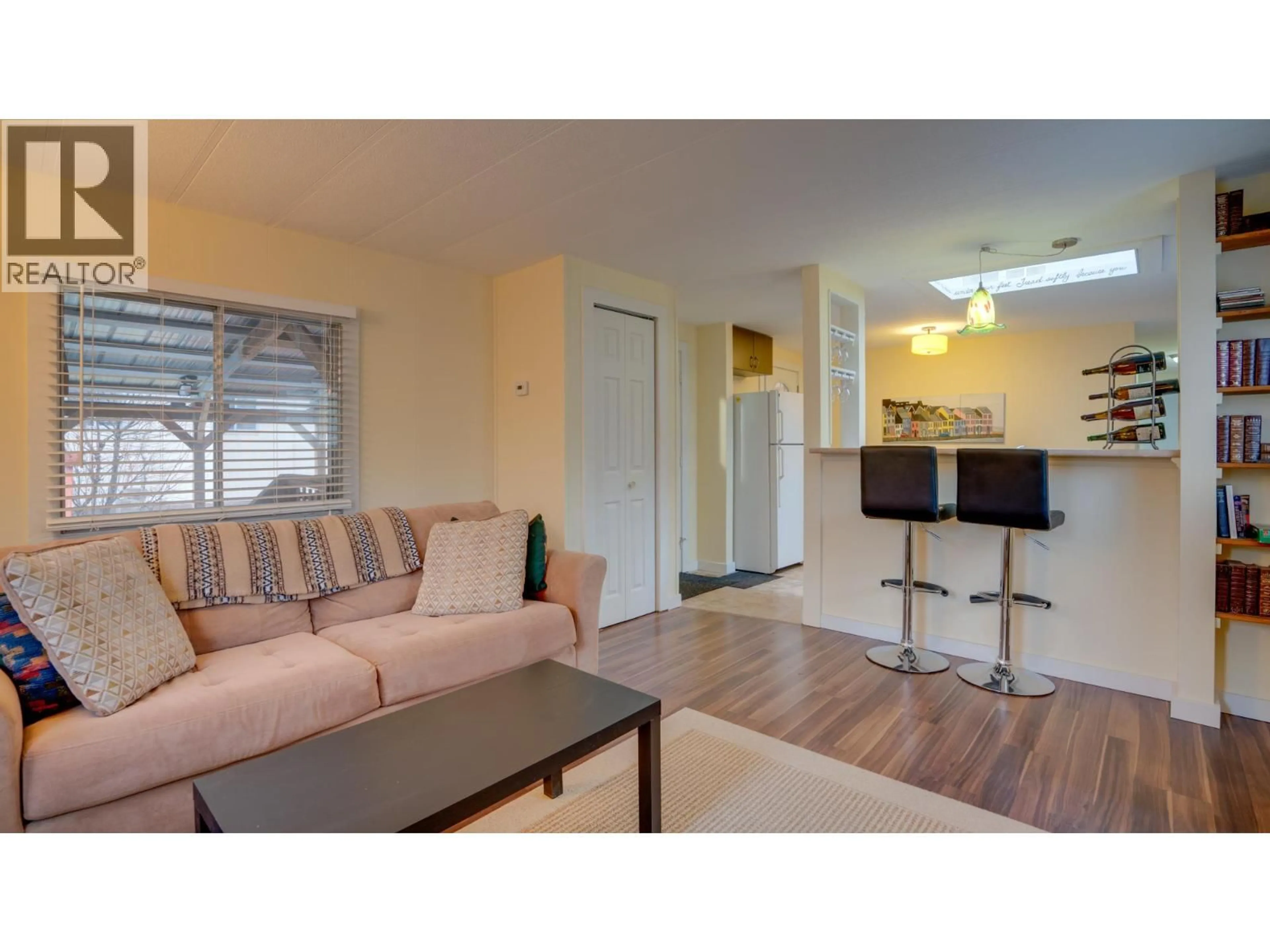 Living room with furniture, wood/laminate floor for 67 - 15401 KALAMALKA LAKE ROAD, Coldstream British Columbia V1B1Z3