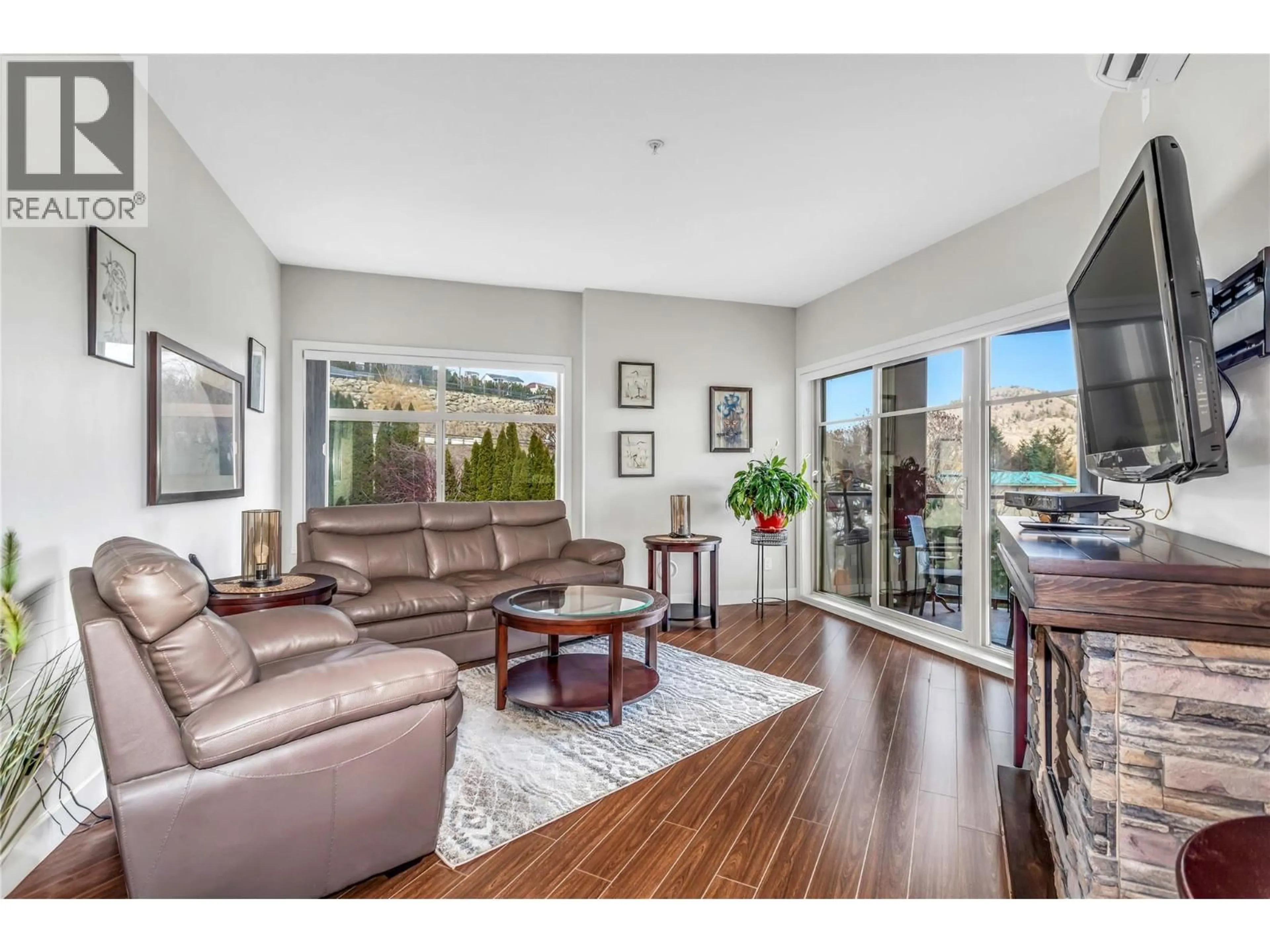 Living room with furniture, wood/laminate floor for 409 - 3205 SKYVIEW LANE, West Kelowna British Columbia V4T3J3