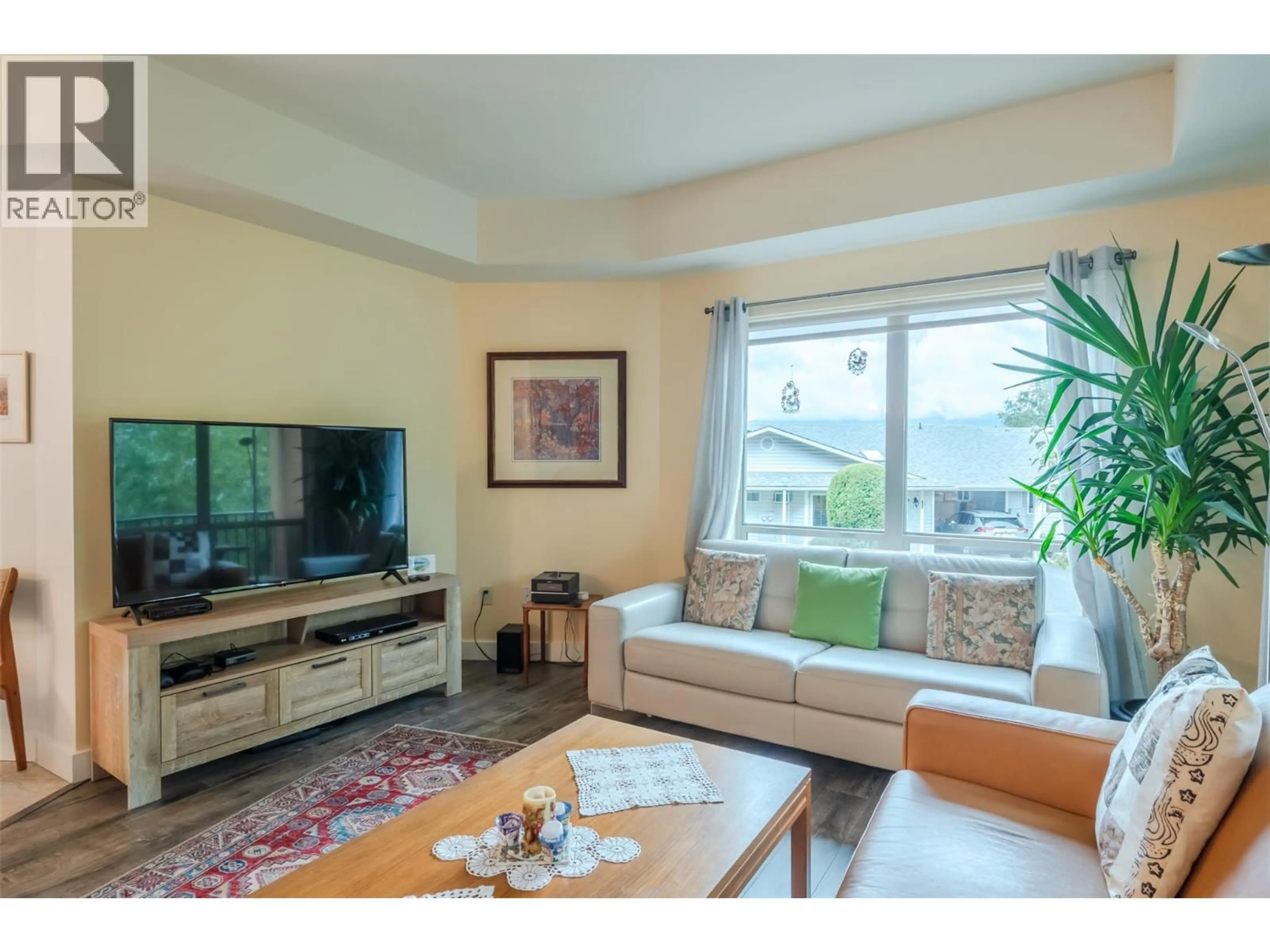 Living room with furniture, wood/laminate floor for 105 - 873 FORESTBROOK DRIVE, Penticton British Columbia V2A2E9