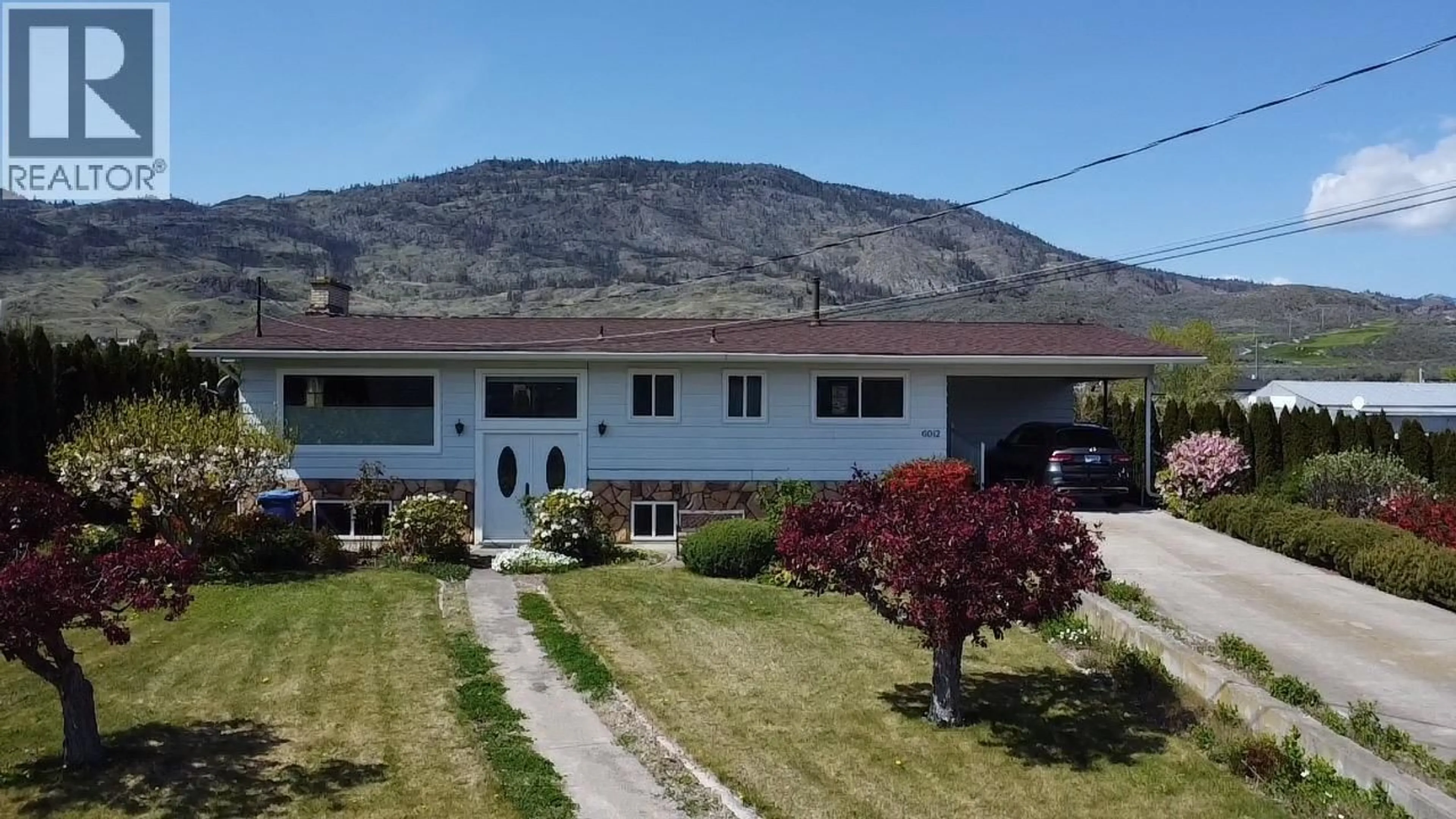 A pic from outside/outdoor area/front of a property/back of a property/a pic from drone, mountain view for 6012 107TH STREET, Osoyoos British Columbia V0H1V2