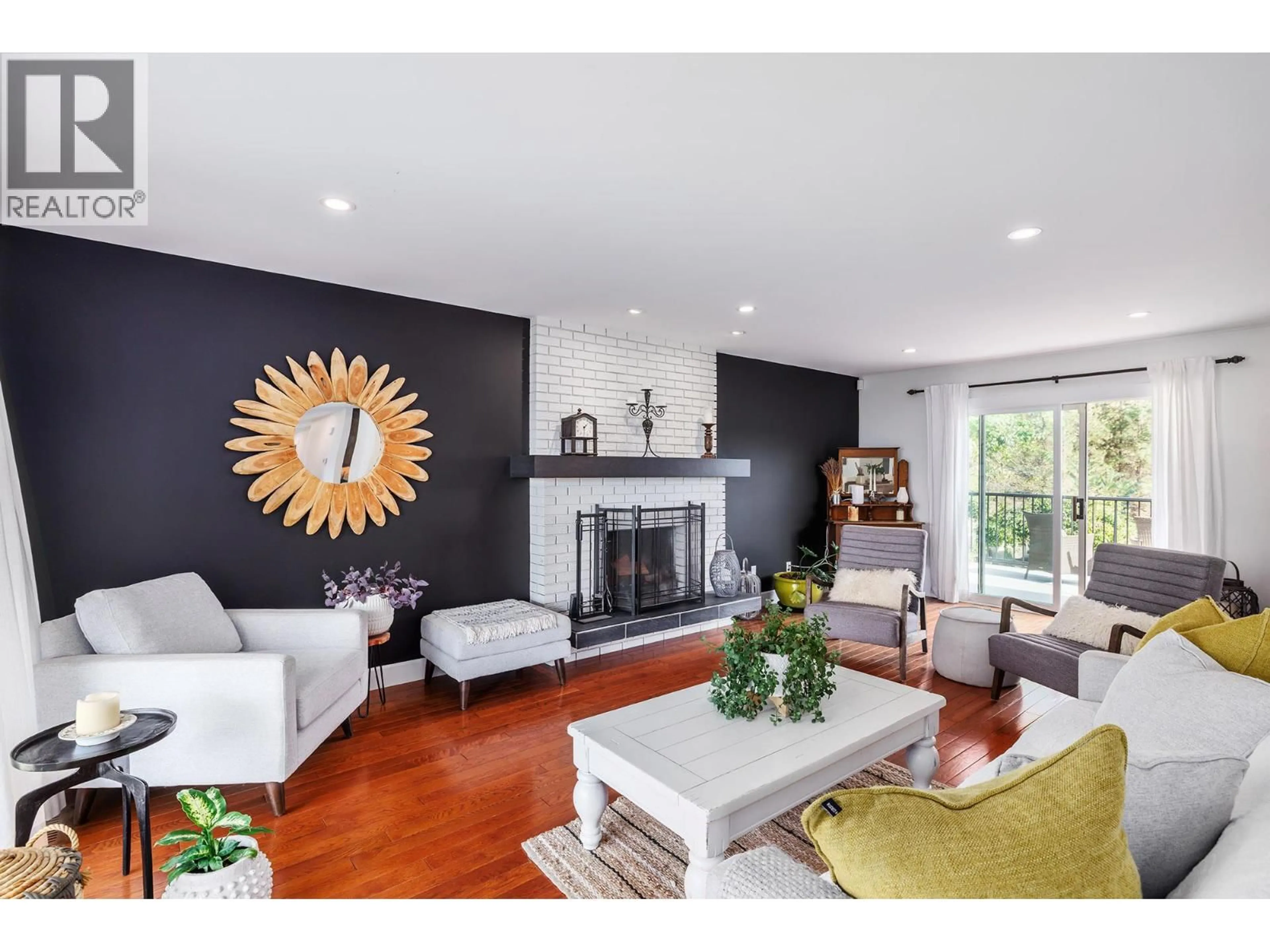 Living room with furniture, wood/laminate floor for 841 CHURCHILL COURT, Kelowna British Columbia V1Y8J4