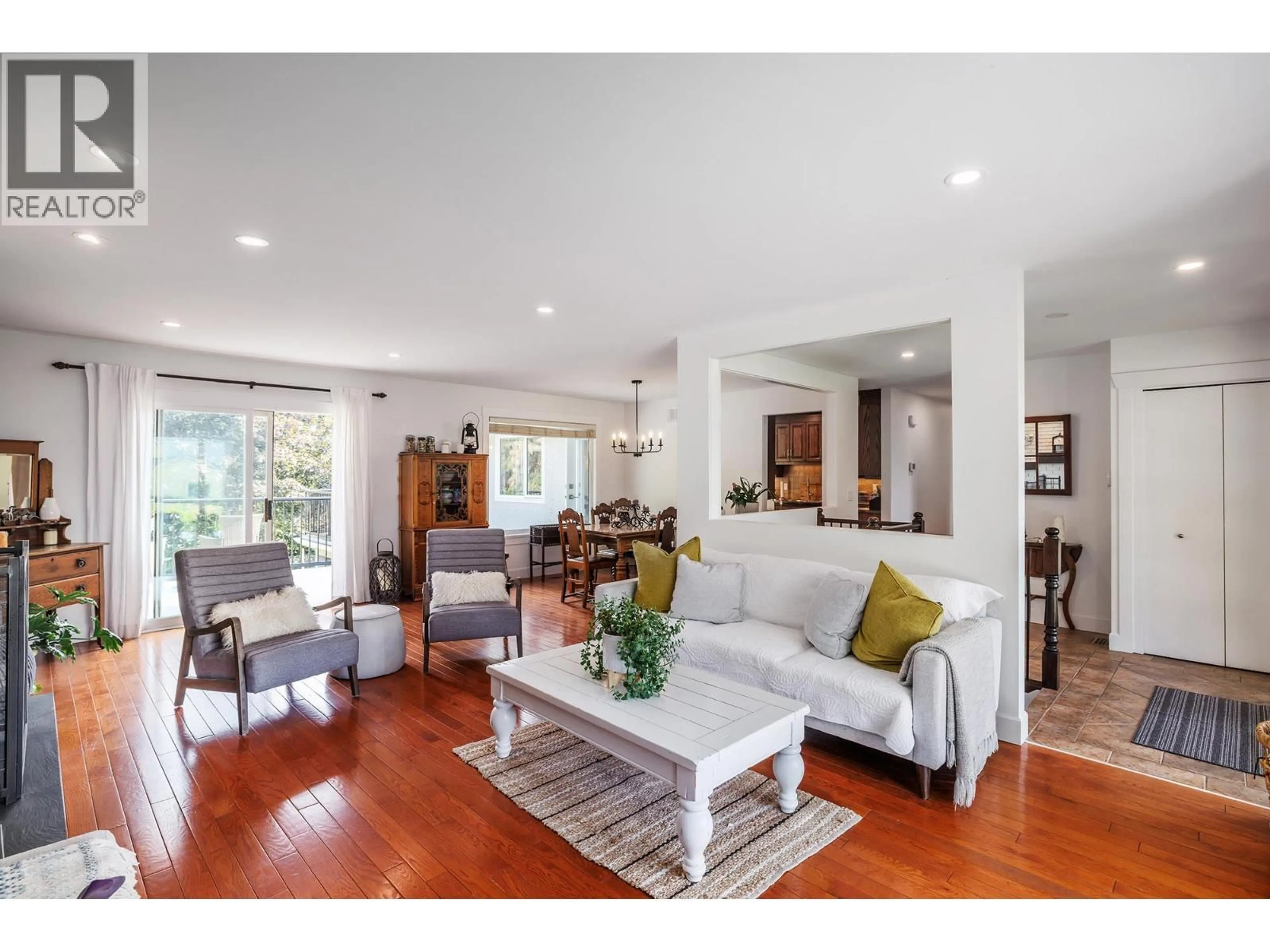 Living room with furniture, wood/laminate floor for 841 CHURCHILL COURT, Kelowna British Columbia V1Y8J4