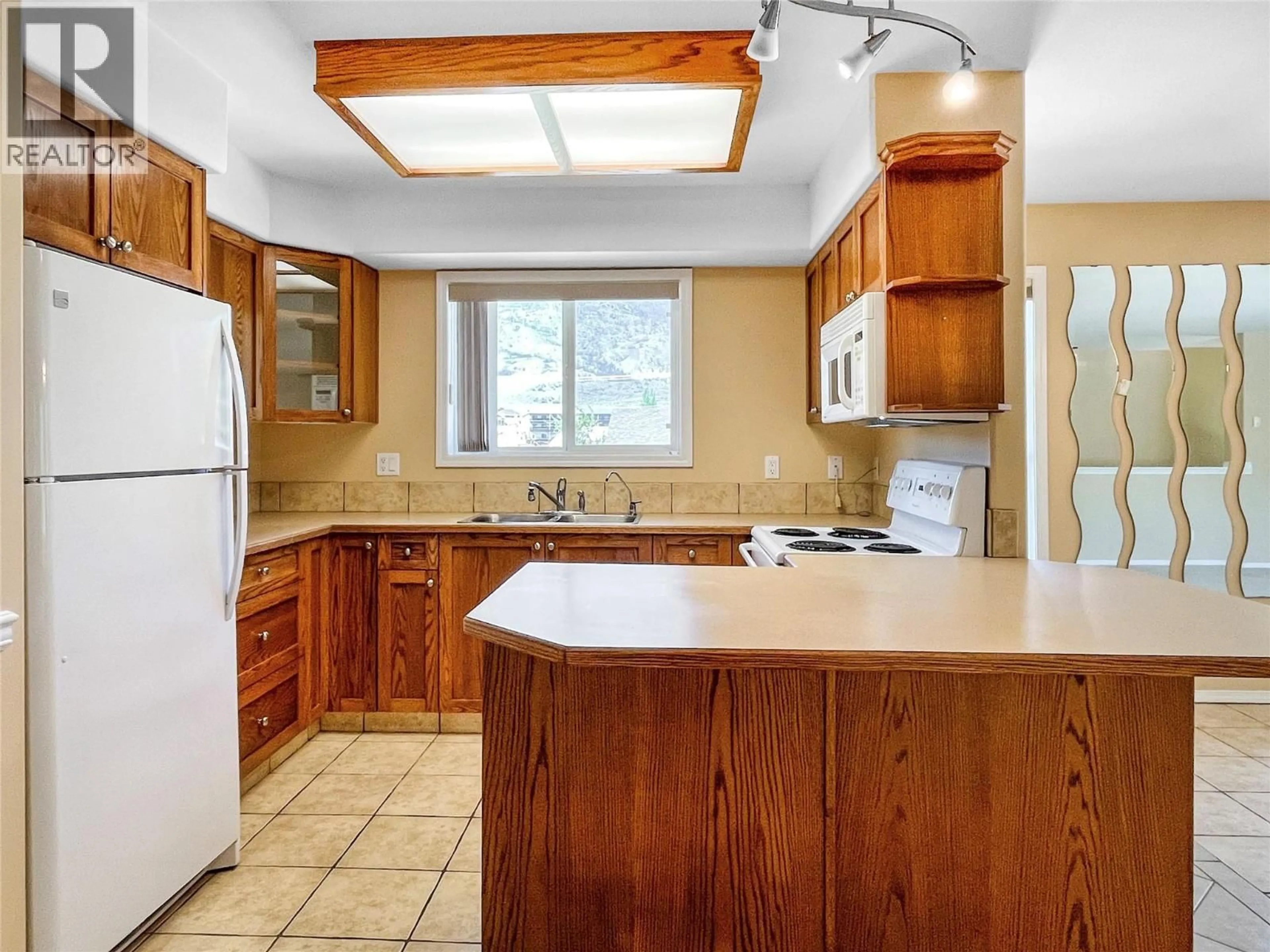 Standard kitchen, ceramic/tile floor for 4 8507 70TH AVENUE, Osoyoos British Columbia V0H1V0