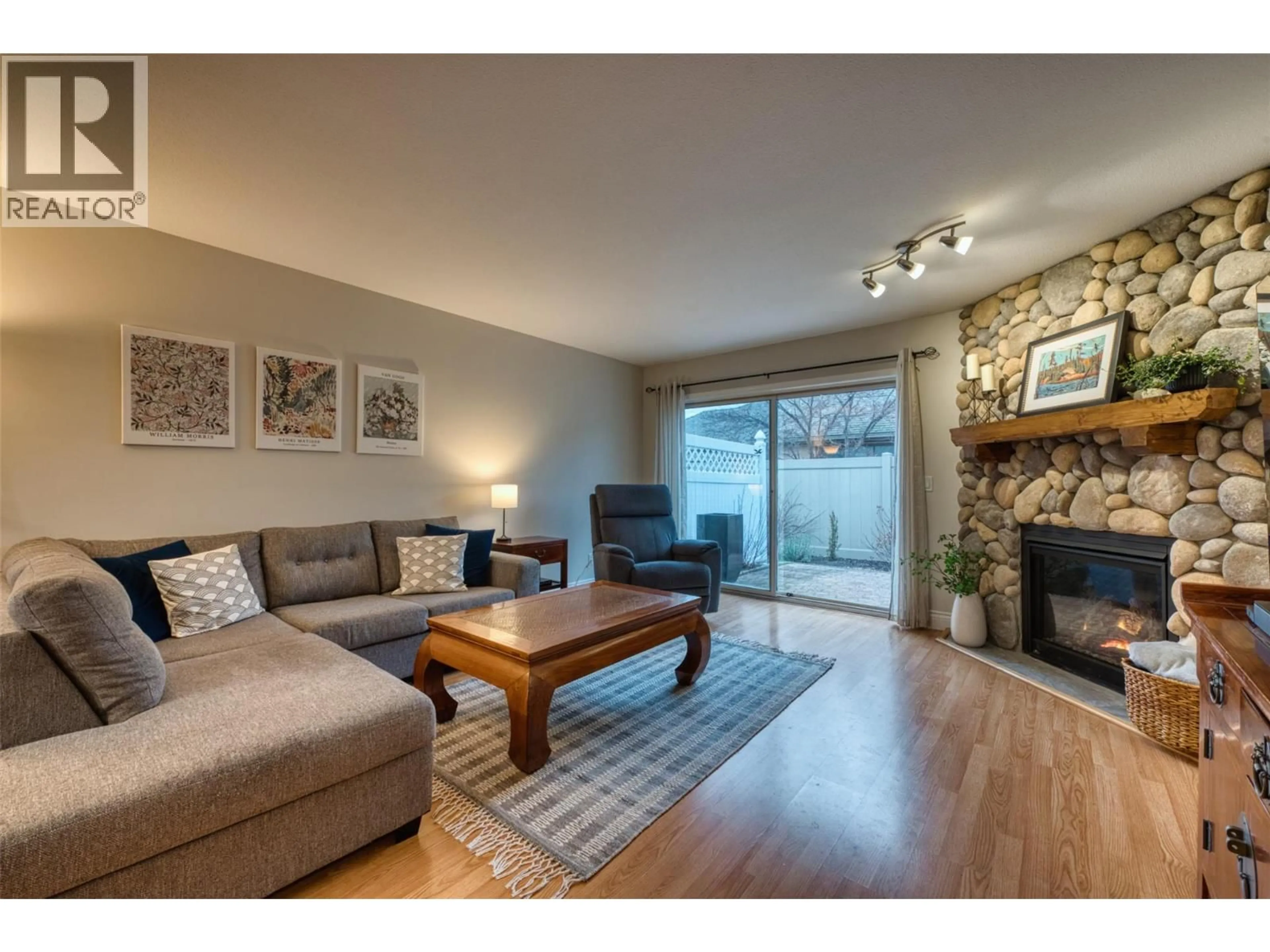 Living room with furniture, wood/laminate floor for 36 - 1020 LANFRANCO ROAD, Kelowna British Columbia V1W3W6