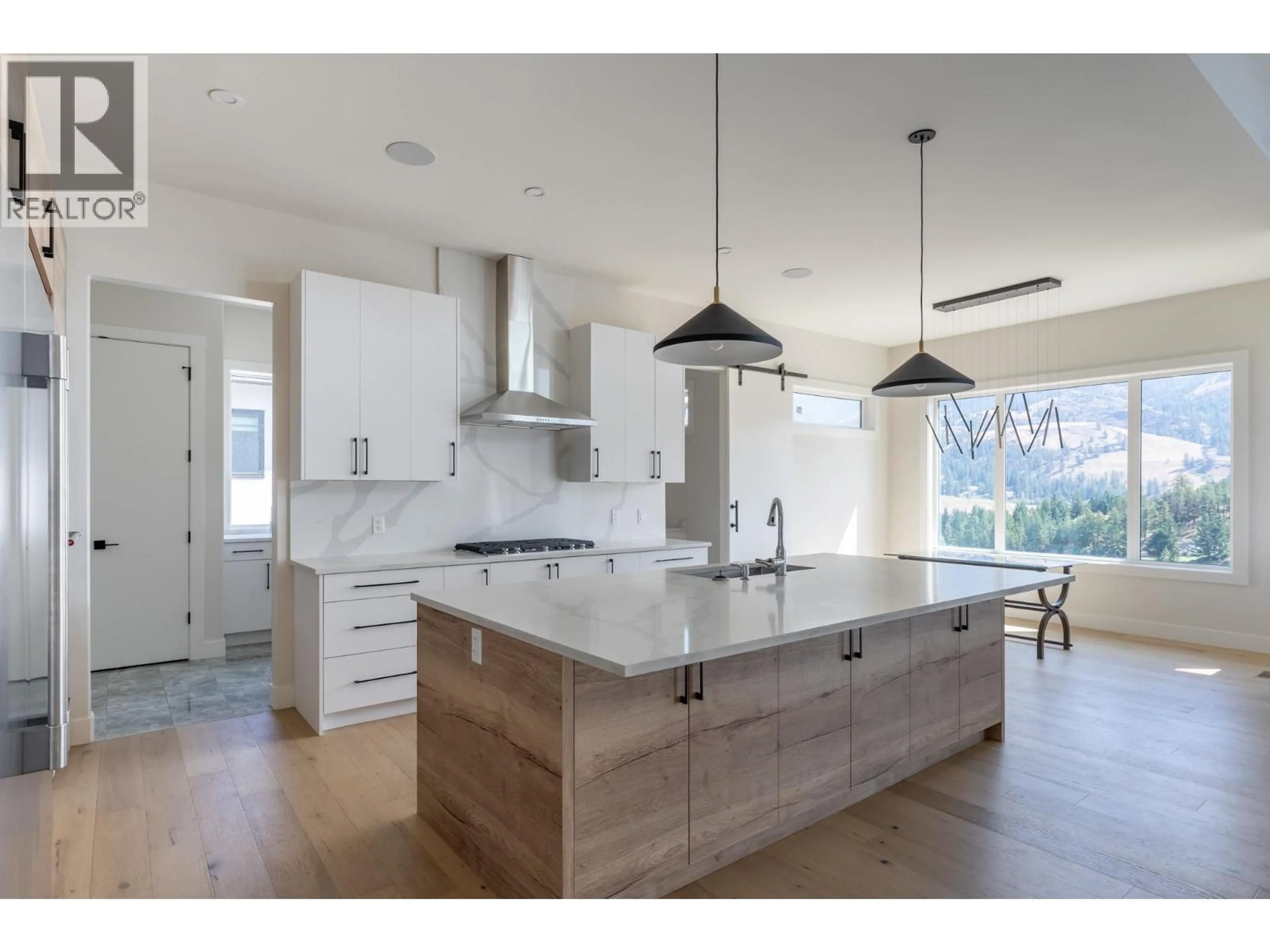 Open concept kitchen, wood/laminate floor for 873 ROYAL TROON LANE, Kelowna British Columbia V1P0A3