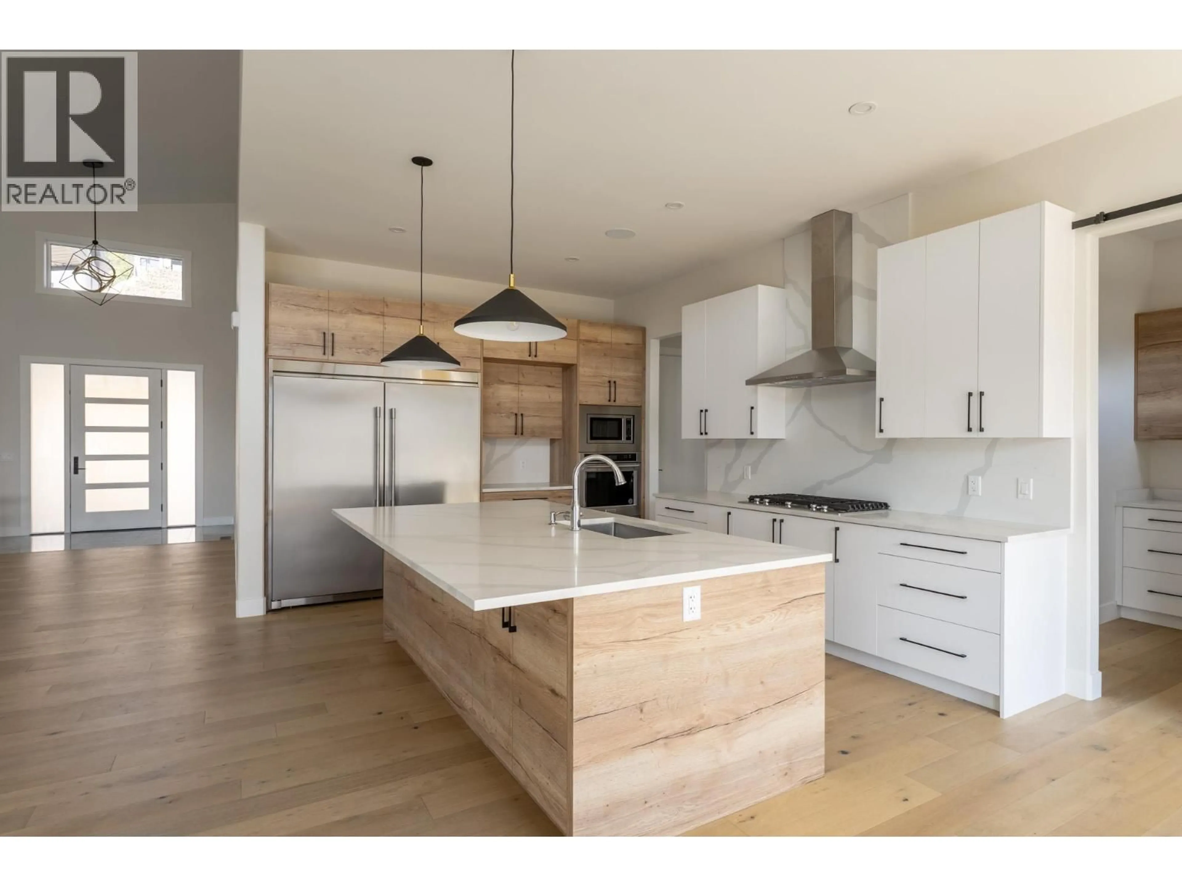 Open concept kitchen, wood/laminate floor for 873 ROYAL TROON LANE, Kelowna British Columbia V1P0A3