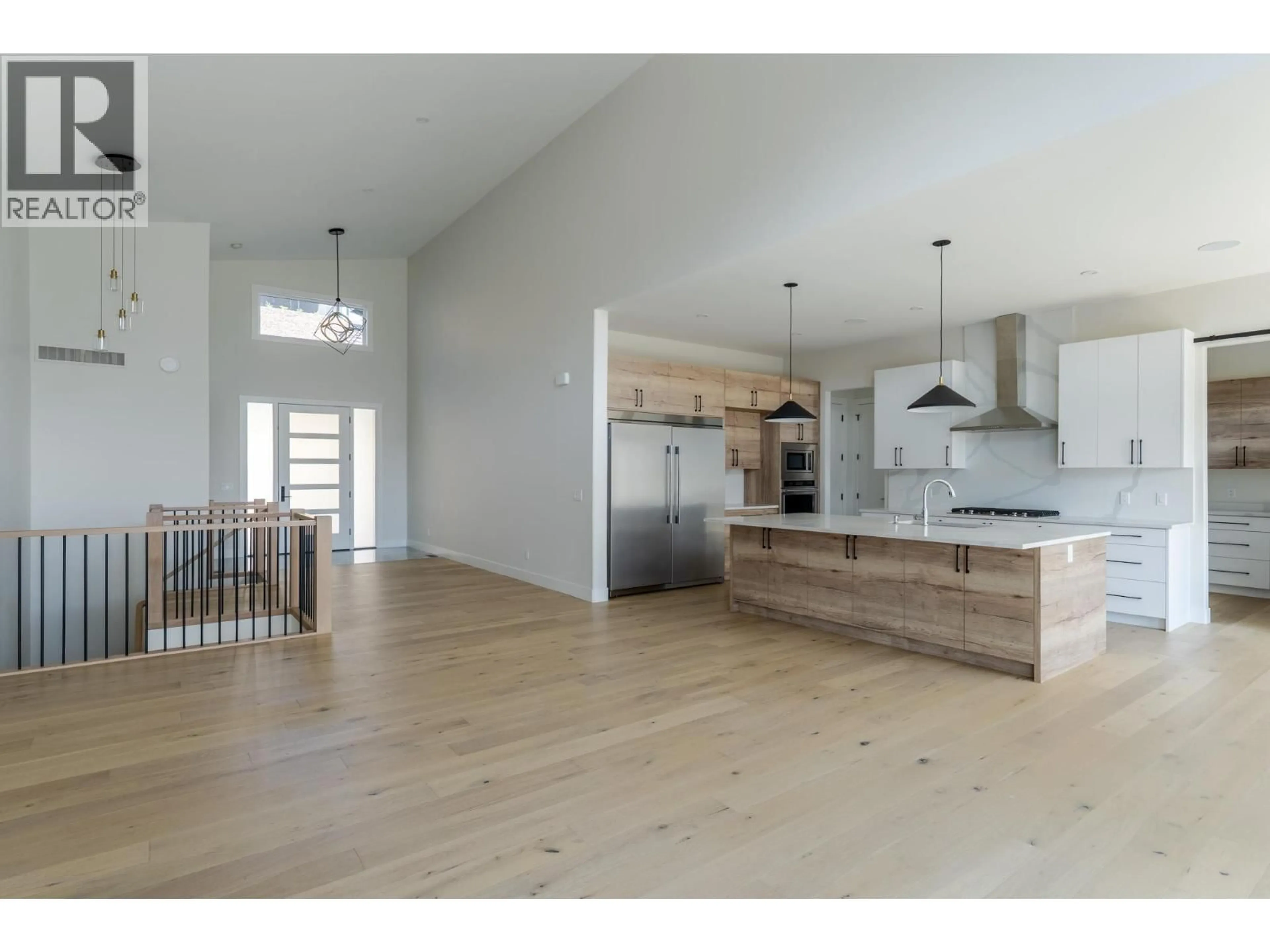 Open concept kitchen, wood/laminate floor for 873 ROYAL TROON LANE, Kelowna British Columbia V1P0A3