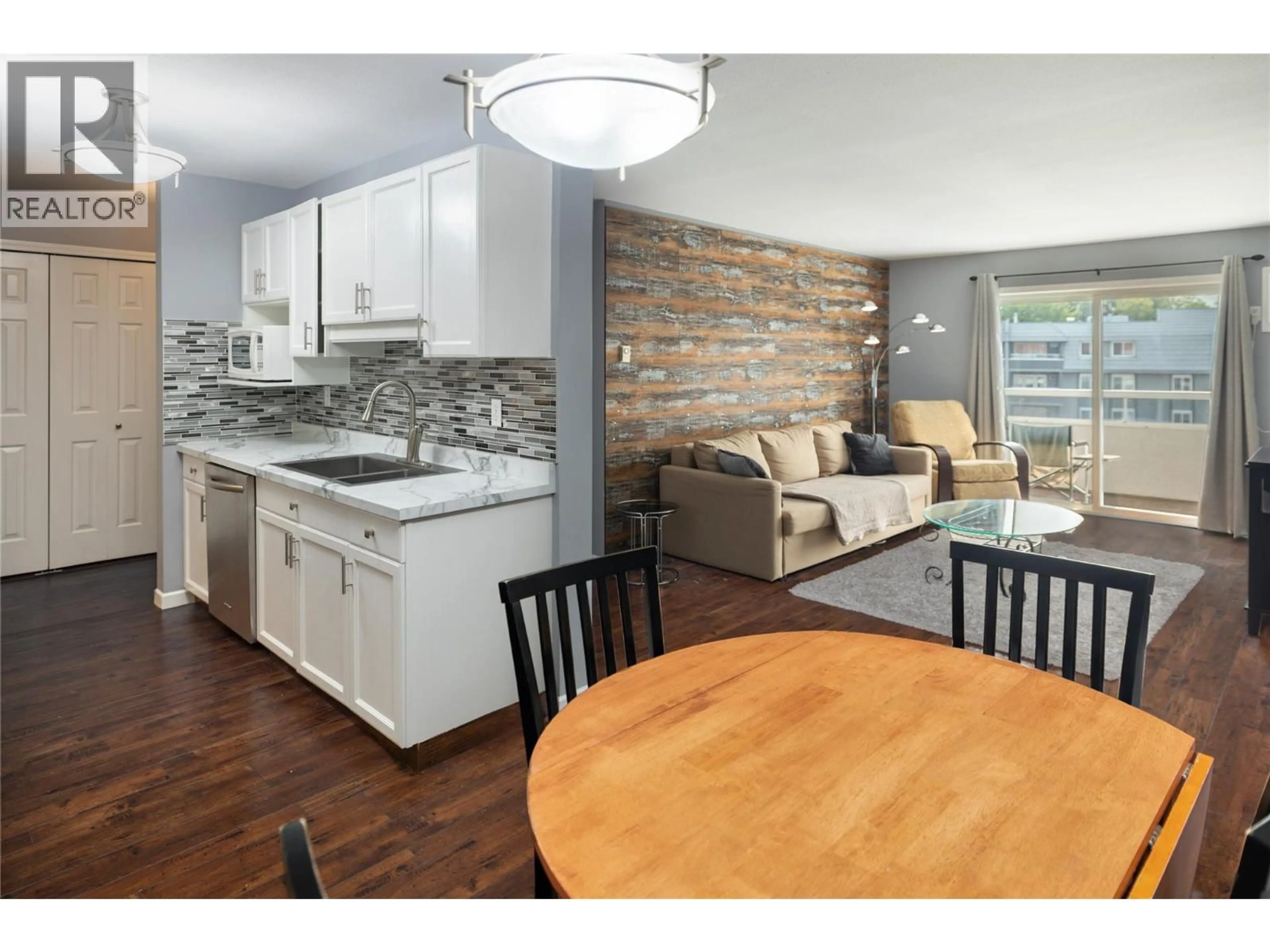 Open concept kitchen, wood/laminate floor for 404 - 3155 DE MONTREUIL COURT, Kelowna British Columbia V1W3W1