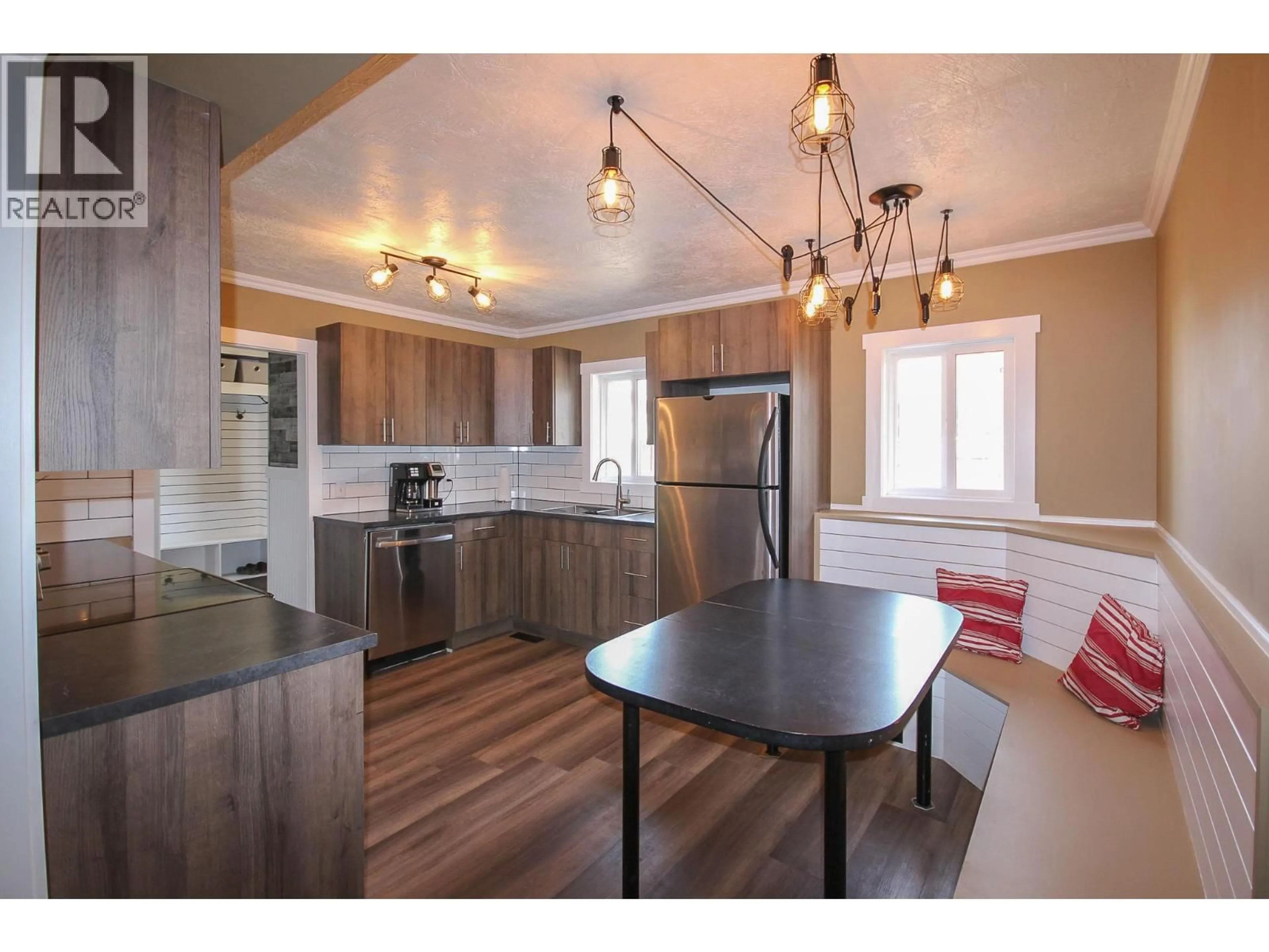 Open concept kitchen, wood/laminate floor for 1608 95 AVENUE, Dawson Creek British Columbia V1G1K1