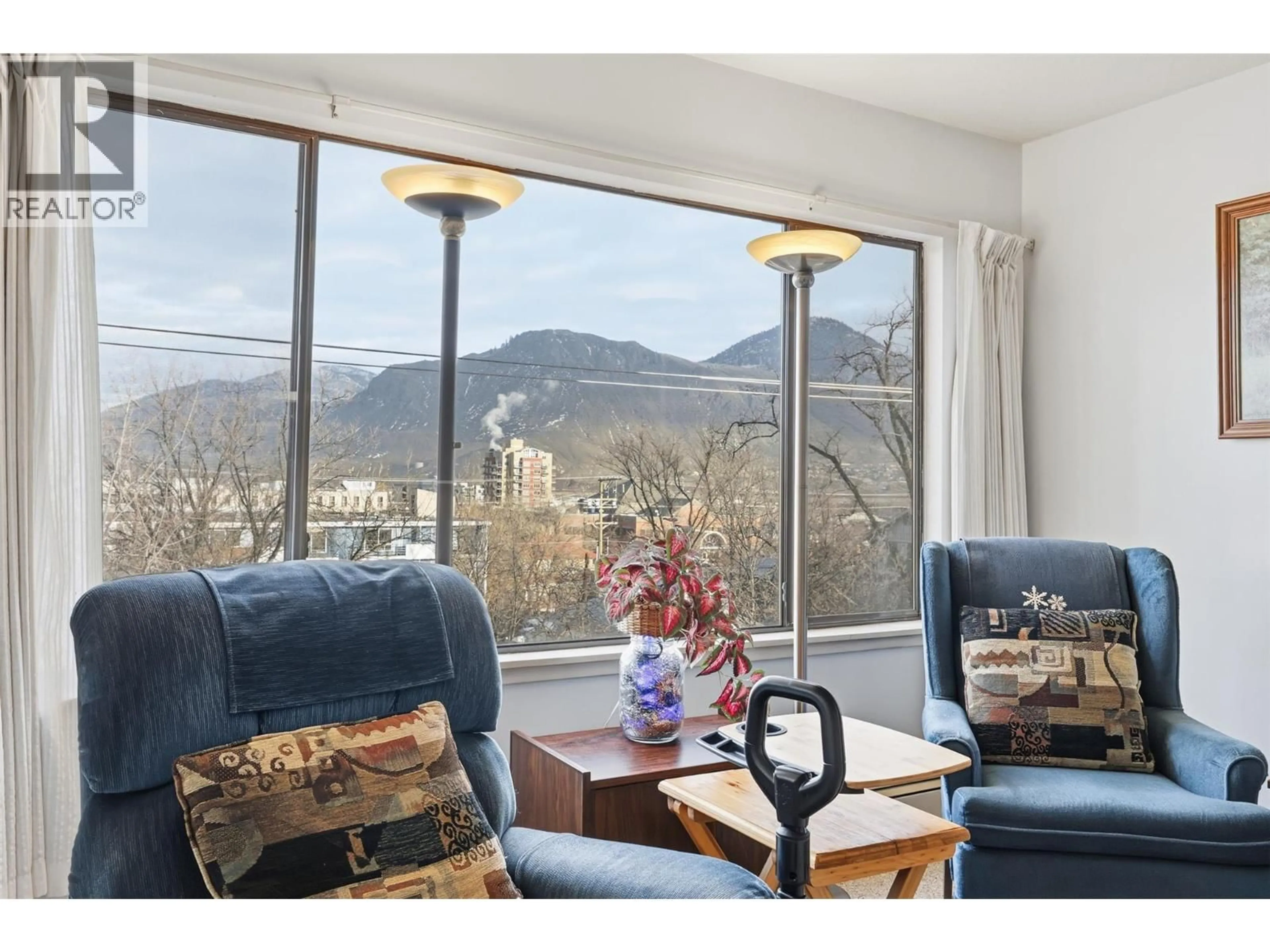 Living room with furniture, wood/laminate floor for 401 - 525 NICOLA STREET, Kamloops British Columbia V2C6J5