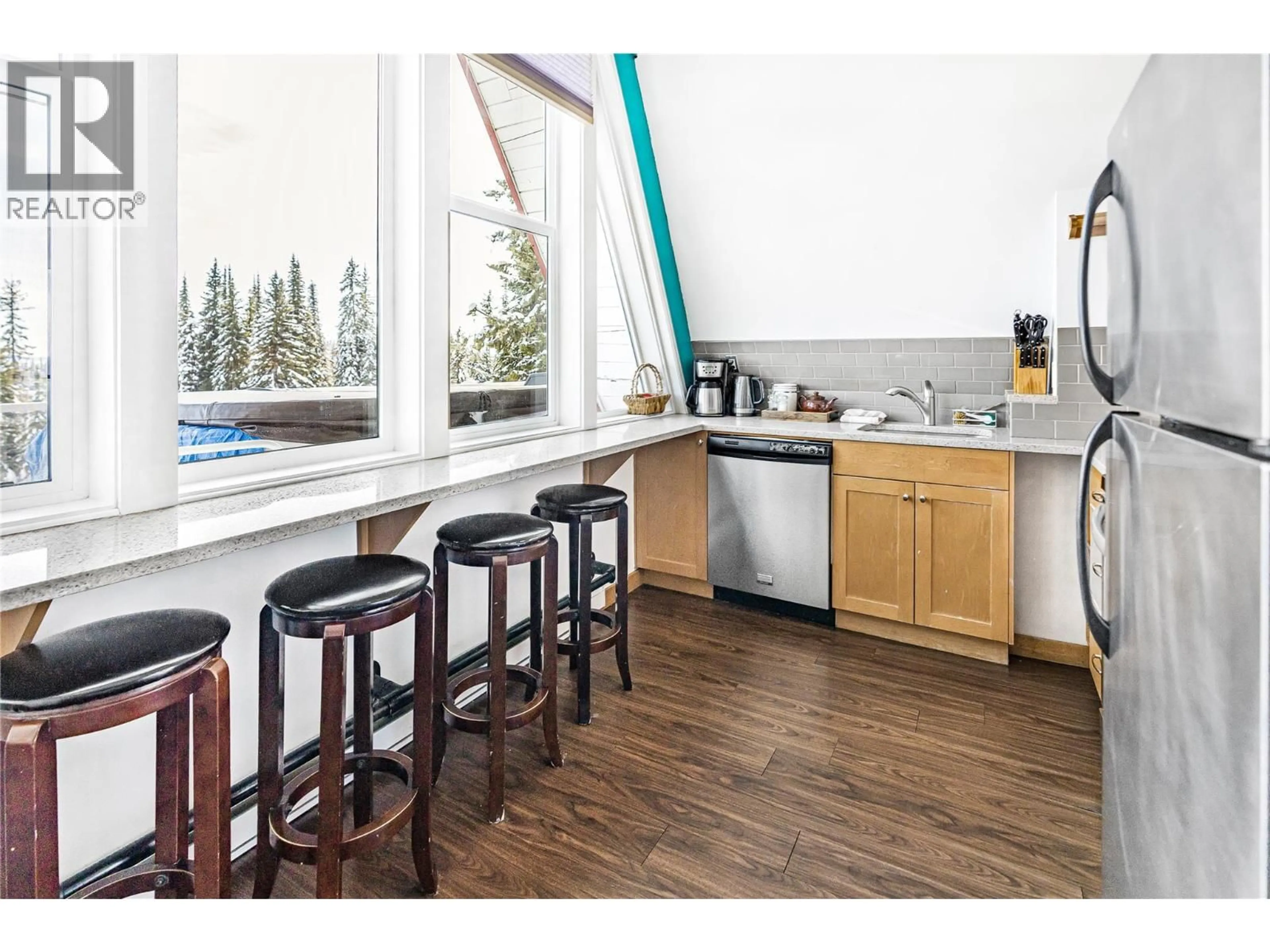 Open concept kitchen, wood/laminate floor for 3 - 9885 PINNACLES ROAD, Vernon British Columbia V1B3M1