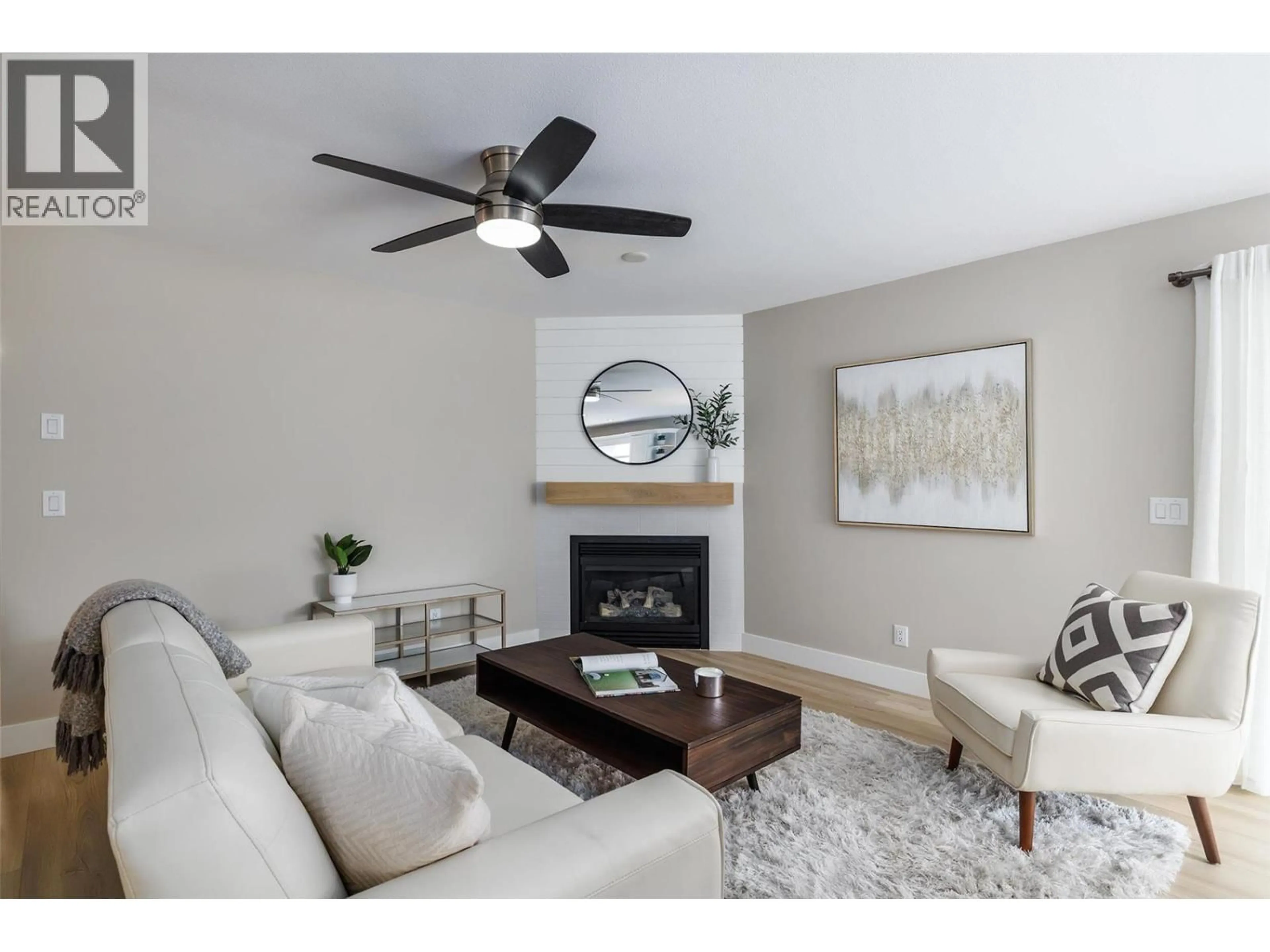 Living room with furniture, wood/laminate floor for 1009 HUDSON ROAD, West Kelowna British Columbia V1Z1J2