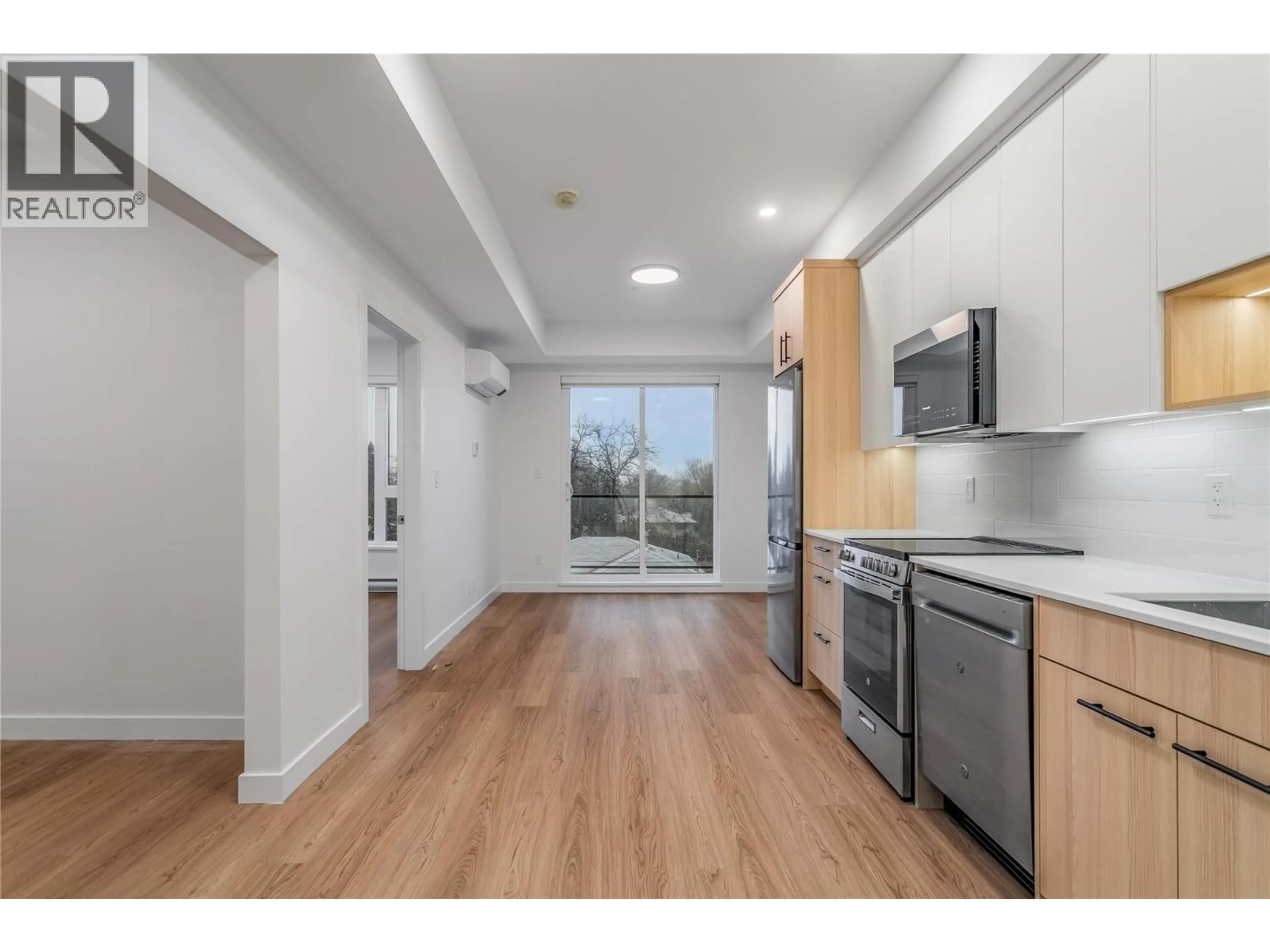 Open concept kitchen, wood/laminate floor for 305 - 1380 PRIDHAM AVENUE, Kelowna British Columbia V1Y6B9