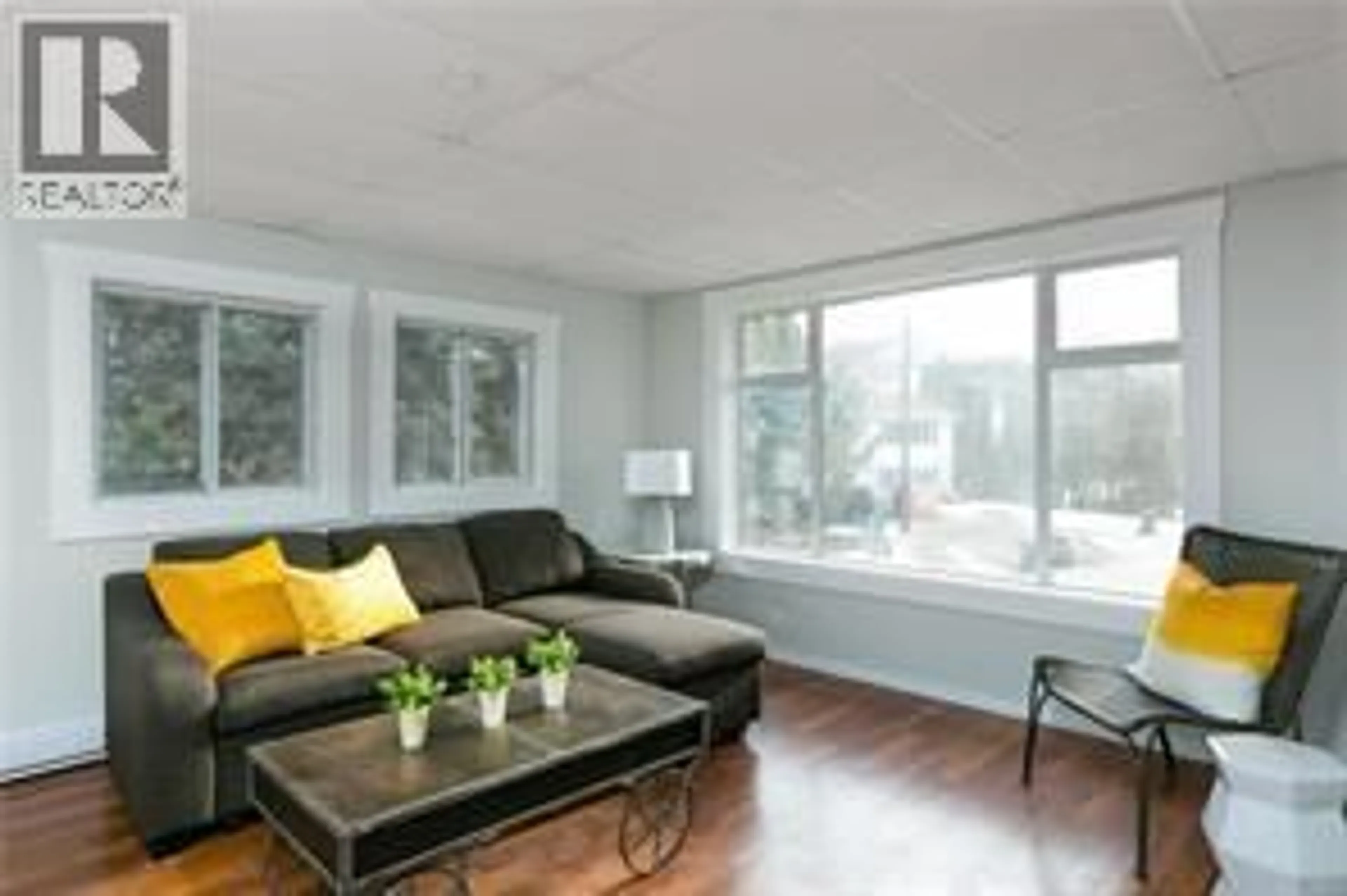 Living room with furniture, wood/laminate floor for 130 DYSART ROAD, Kelowna British Columbia V1X3R1