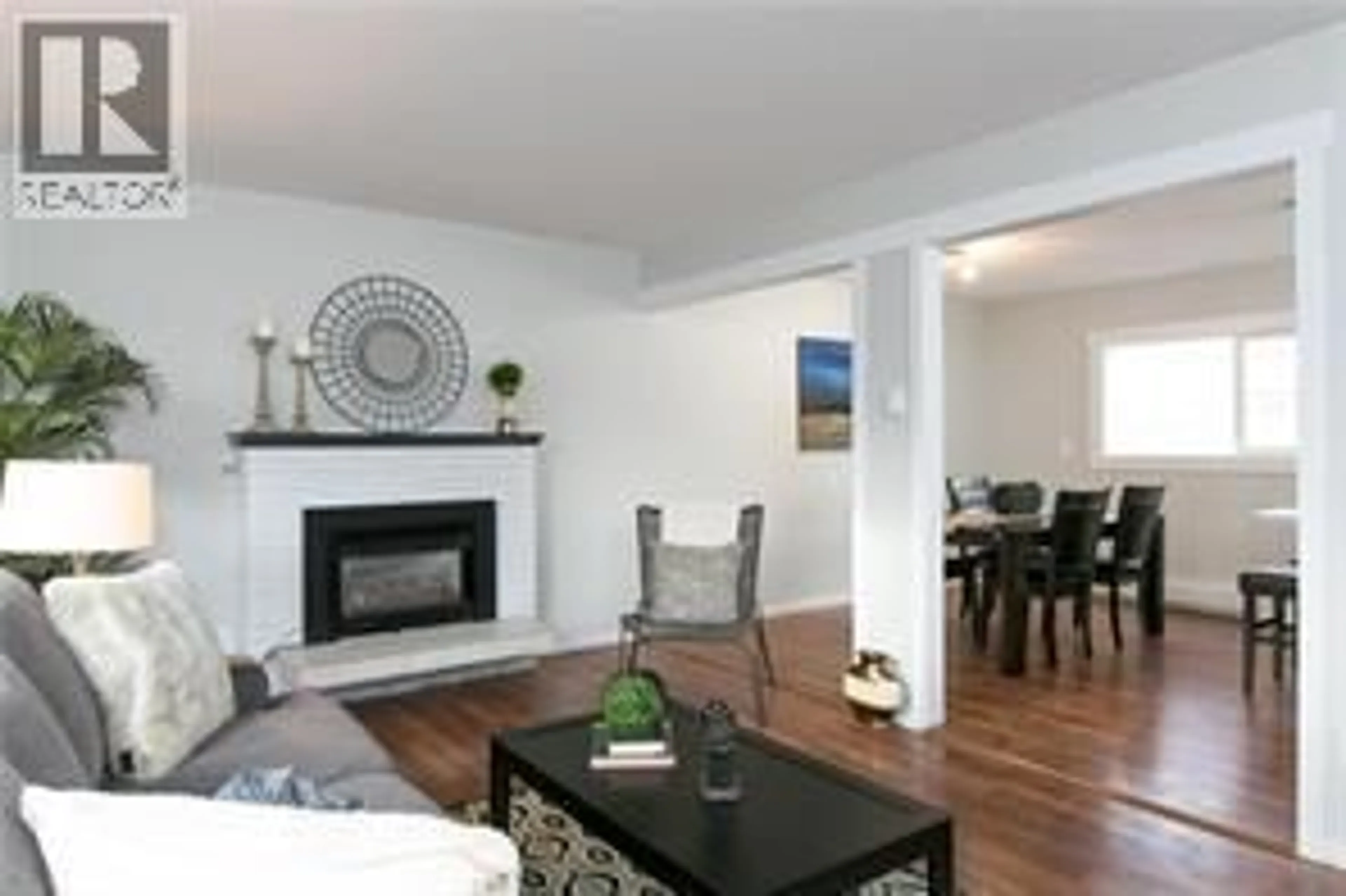 Living room with furniture, wood/laminate floor for 130 DYSART ROAD, Kelowna British Columbia V1X3R1