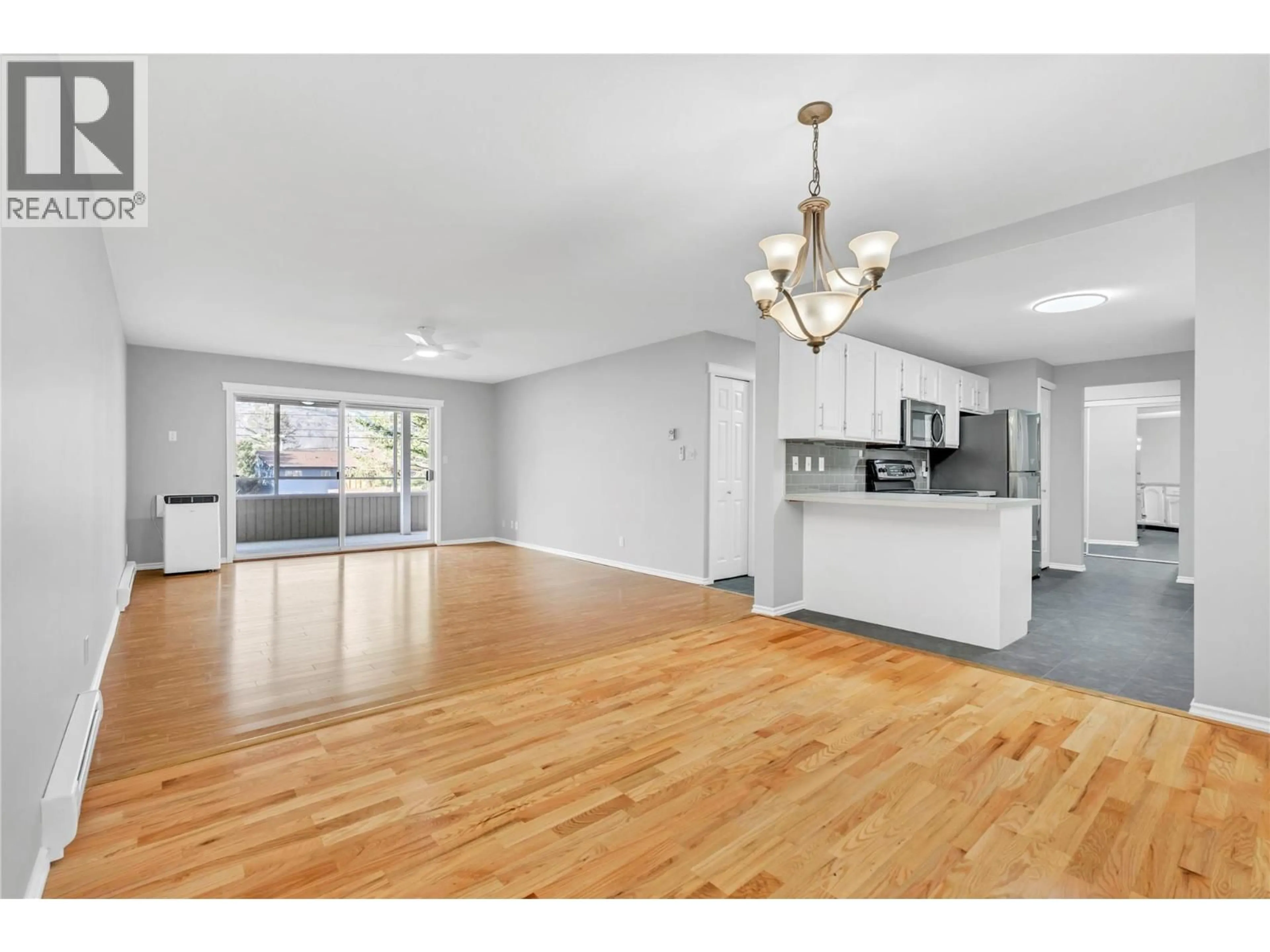 Open concept kitchen, wood/laminate floor for 208 - 272 GREEN AVENUE WEST, Penticton British Columbia V2A3T2