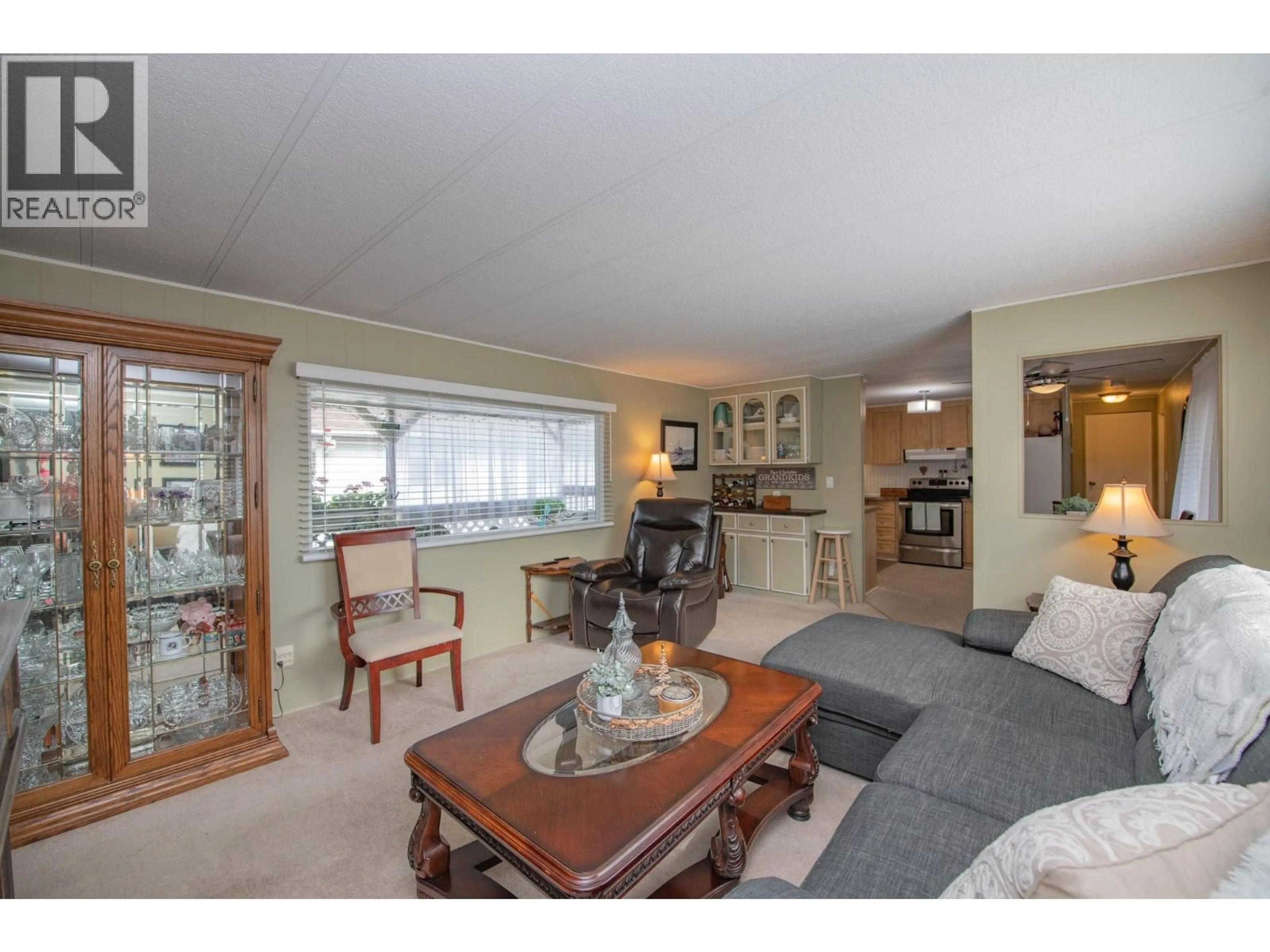 Living room with furniture, wood/laminate floor for 3A - 15401 KALAMALKA LAKE ROAD, Coldstream British Columbia V1B1Z3