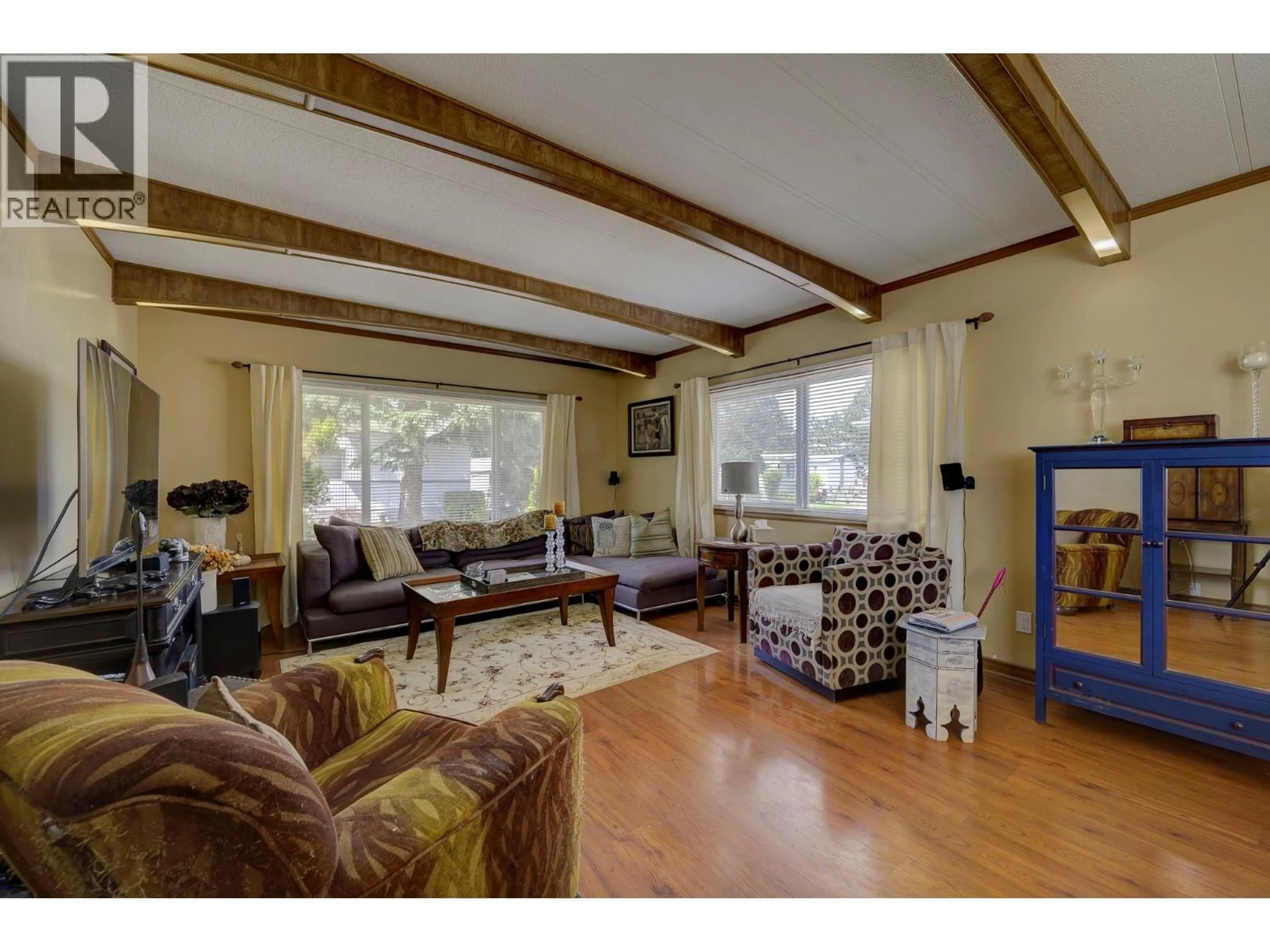 Living room with furniture, wood/laminate floor for 216 - 2400 OAKDALE WAY, Kamloops British Columbia V2B6W7