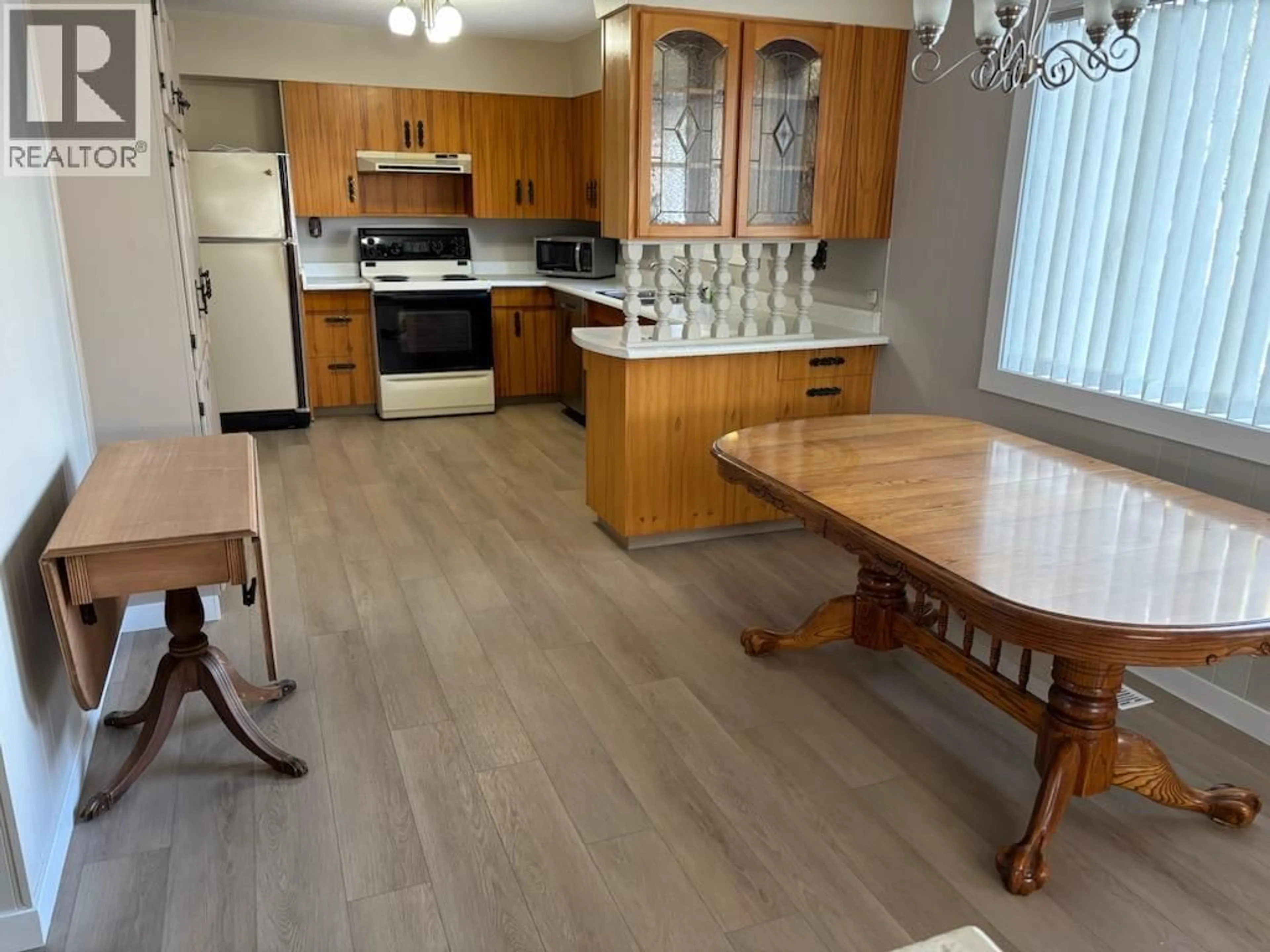 Open concept kitchen, wood/laminate floor for 7551 23RD STREET, Grand Forks British Columbia V0H1H2