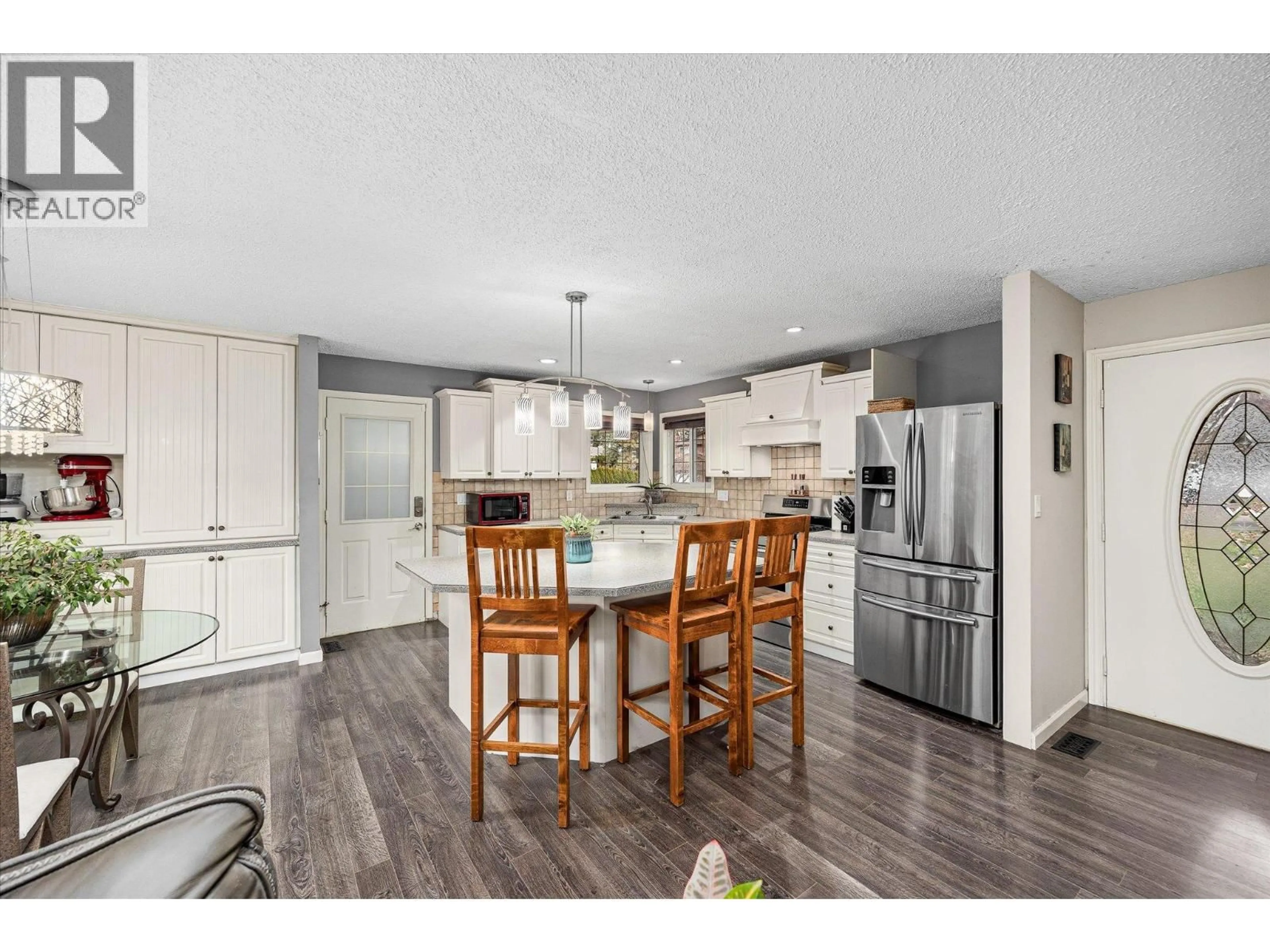 Open concept kitchen, wood/laminate floor for 2435 O'REILLY ROAD, Kelowna British Columbia V1W2V7