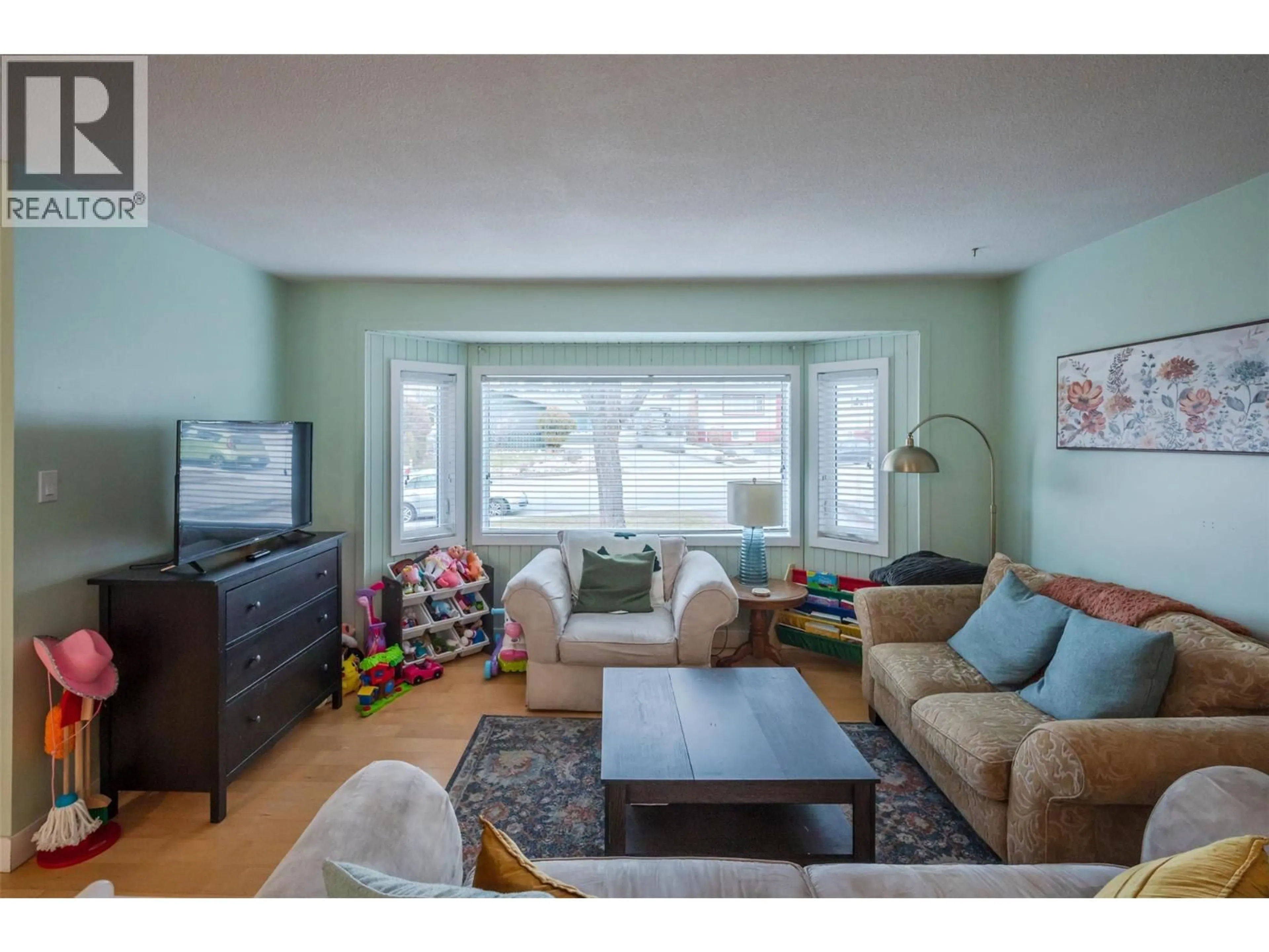 Living room with furniture, wood/laminate floor for 116 MCPHERSON CRESCENT, Penticton British Columbia V2A2N8