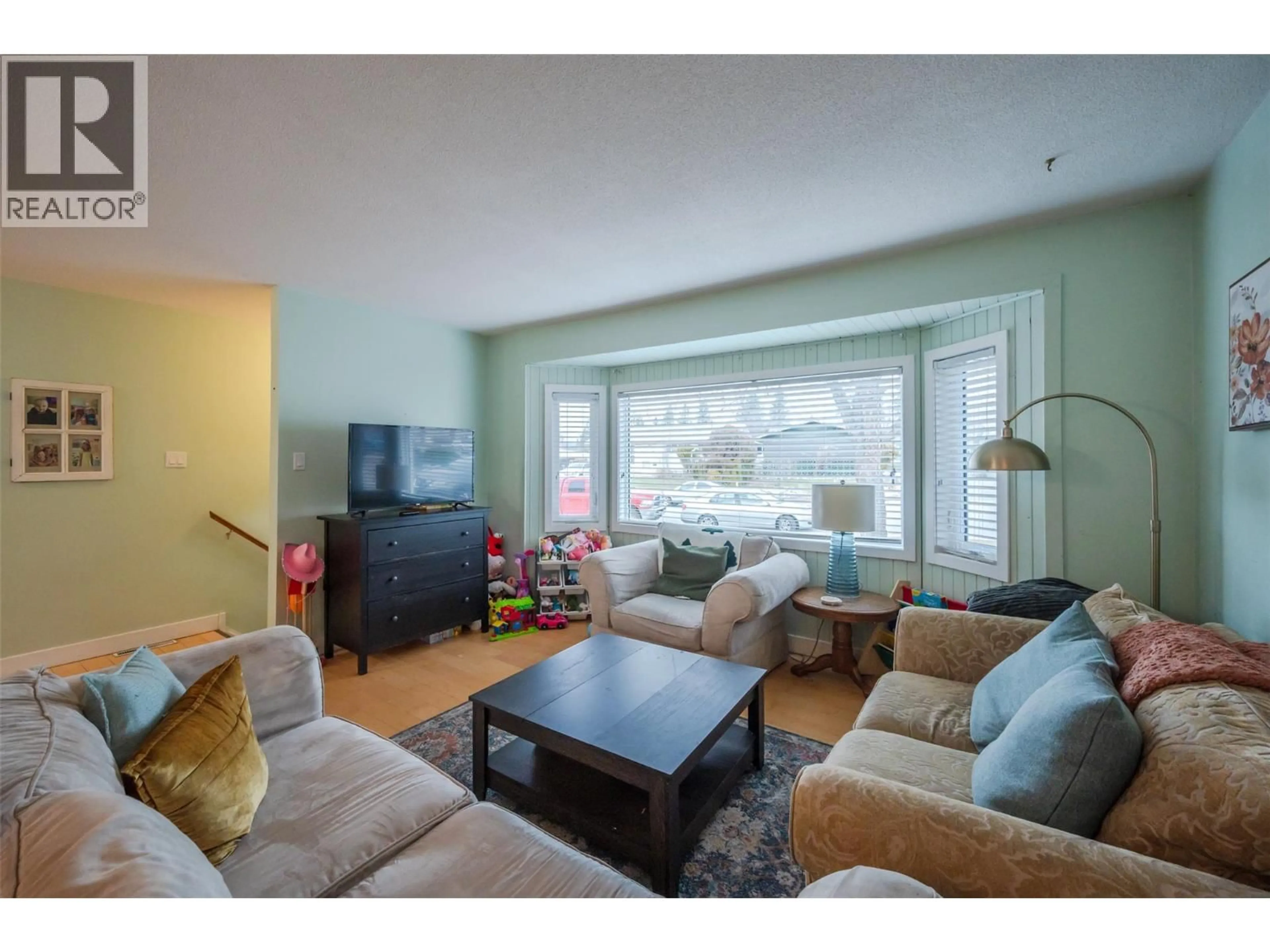 Living room with furniture, wood/laminate floor for 116 MCPHERSON CRESCENT, Penticton British Columbia V2A2N8