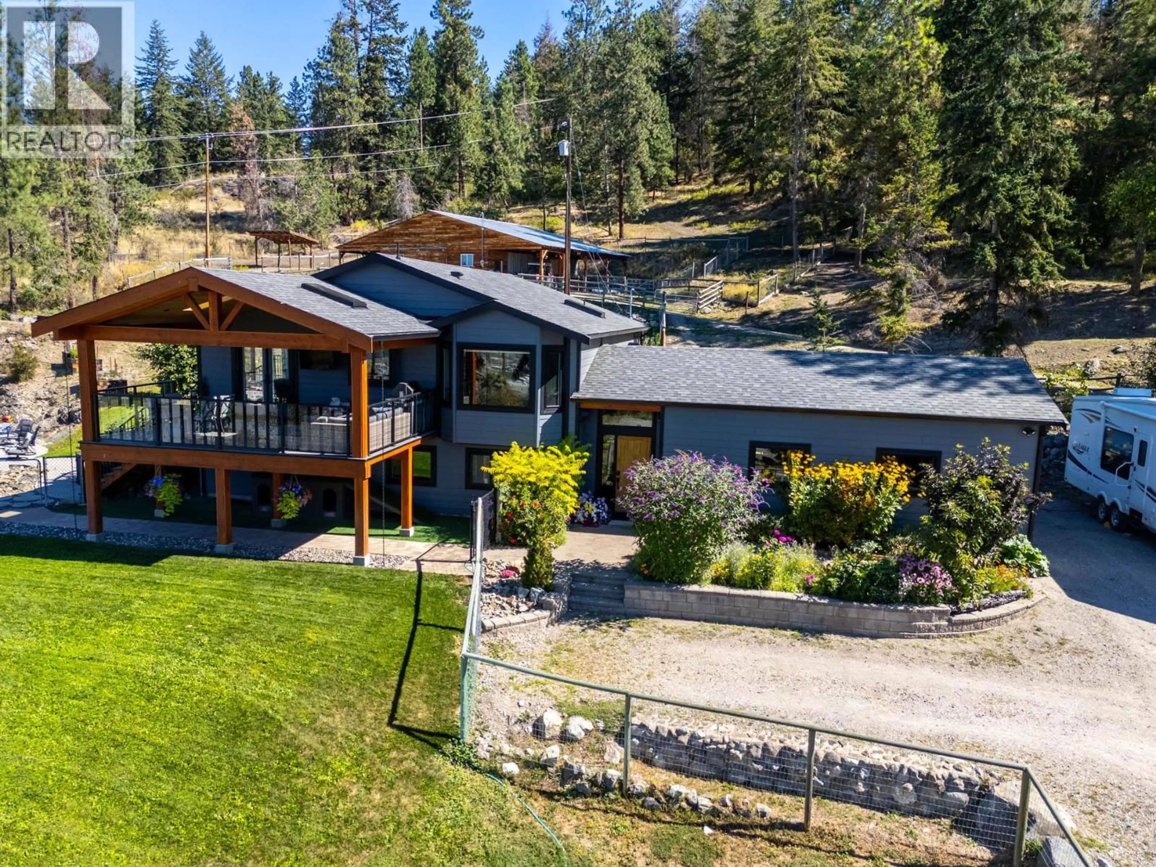 A pic from outside/outdoor area/front of a property/back of a property/a pic from drone, mountain view for 6025 FARMERS DRIVE, Kelowna British Columbia V1P1A3