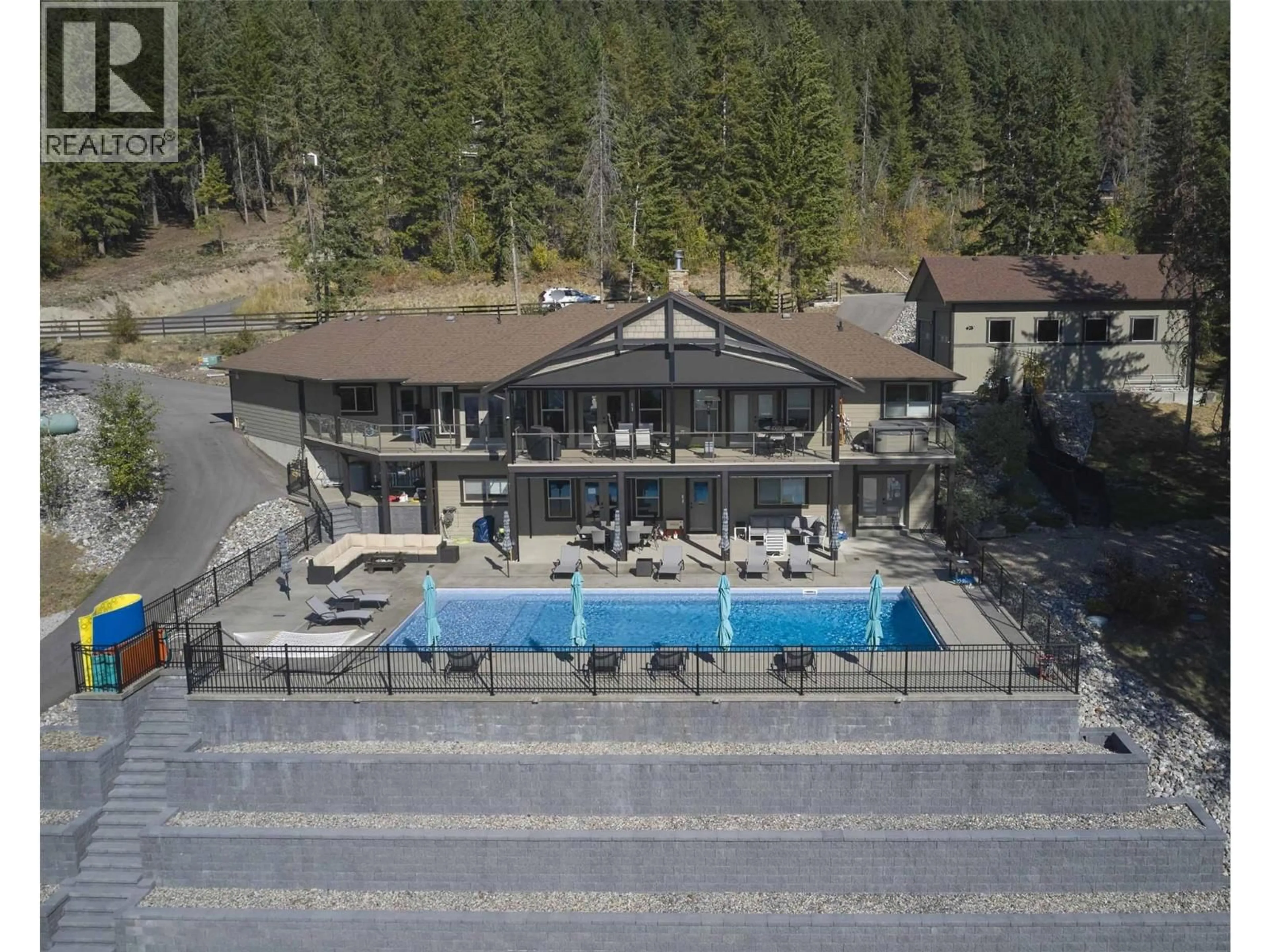 A pic from outside/outdoor area/front of a property/back of a property/a pic from drone, water/lake/river/ocean view for 6032 LYNX DRIVE, Vernon British Columbia V1B3J5
