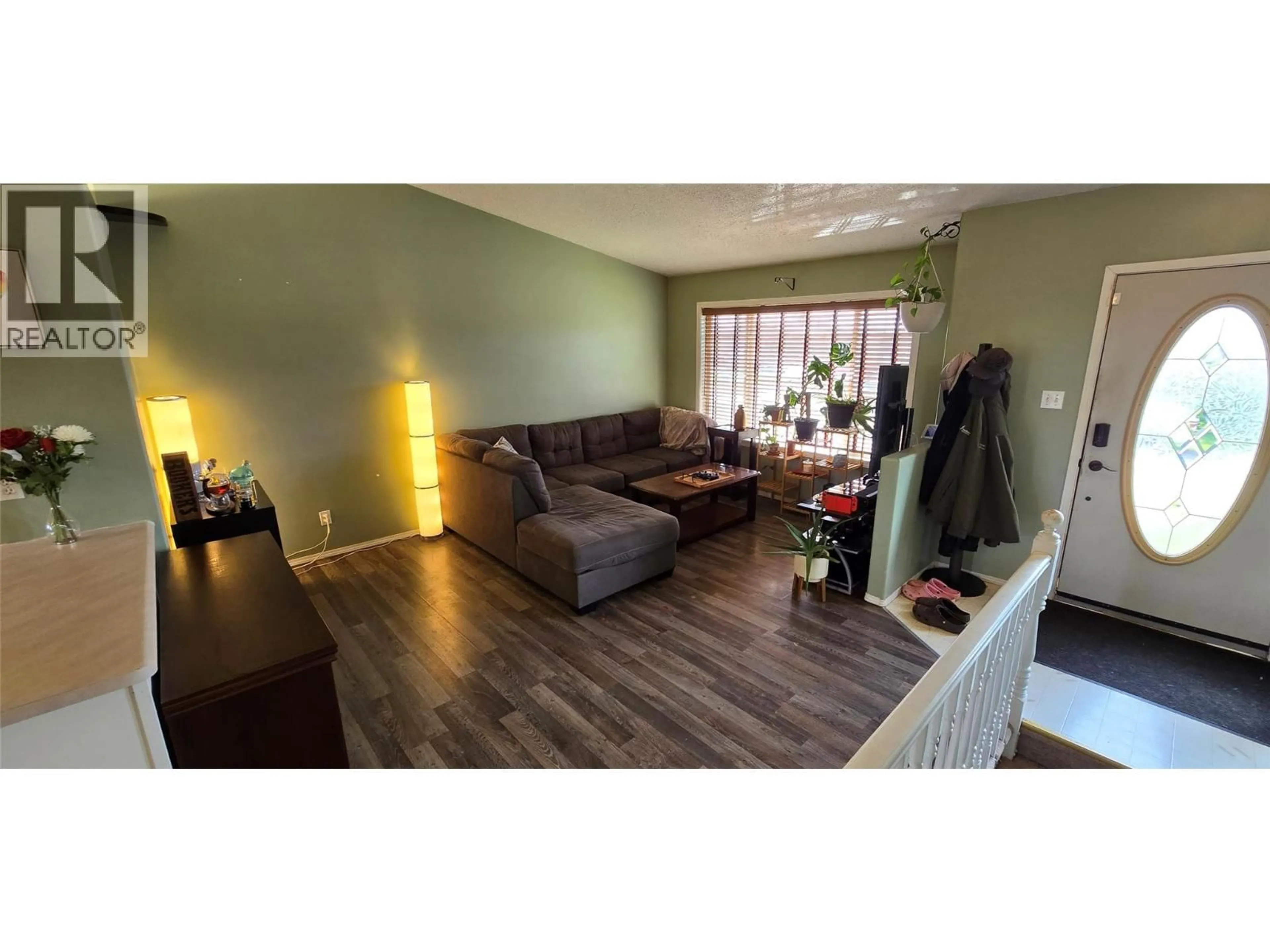 Living room with furniture, wood/laminate floor for 512 98 AVENUE, Dawson Creek British Columbia V1G1R9