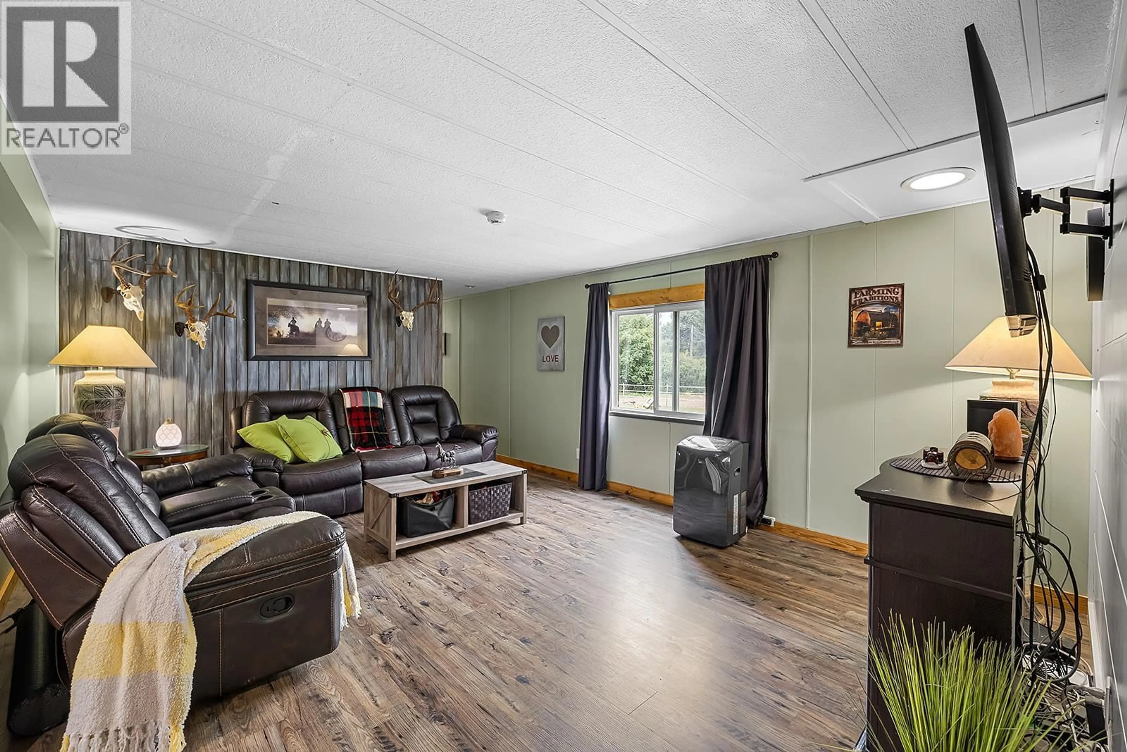 Living room with furniture, wood/laminate floor for 1077 GOAT RIVER SOUTH ROAD, Creston British Columbia V0B1G1