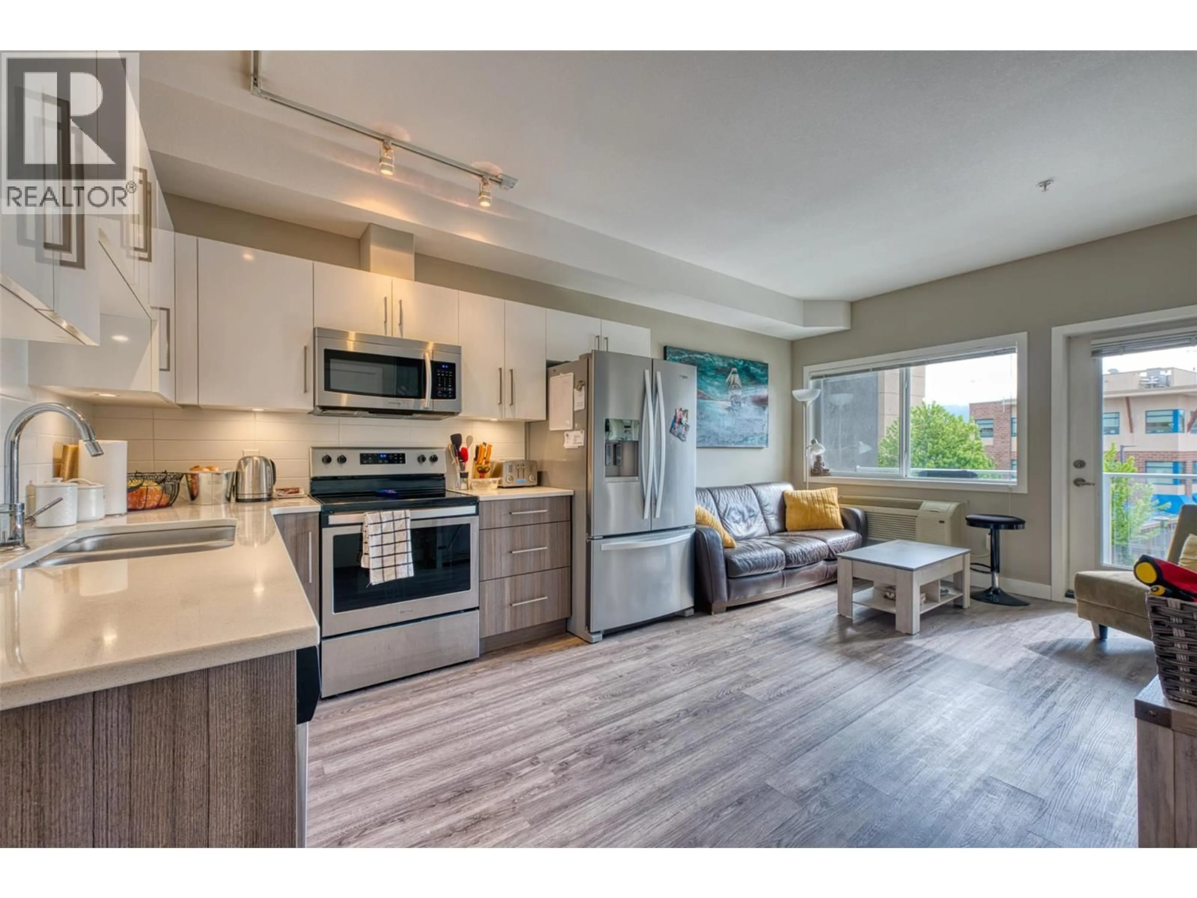 Open concept kitchen, wood/laminate floor for 313 - 3409 28 AVENUE, Vernon British Columbia V1T8J6