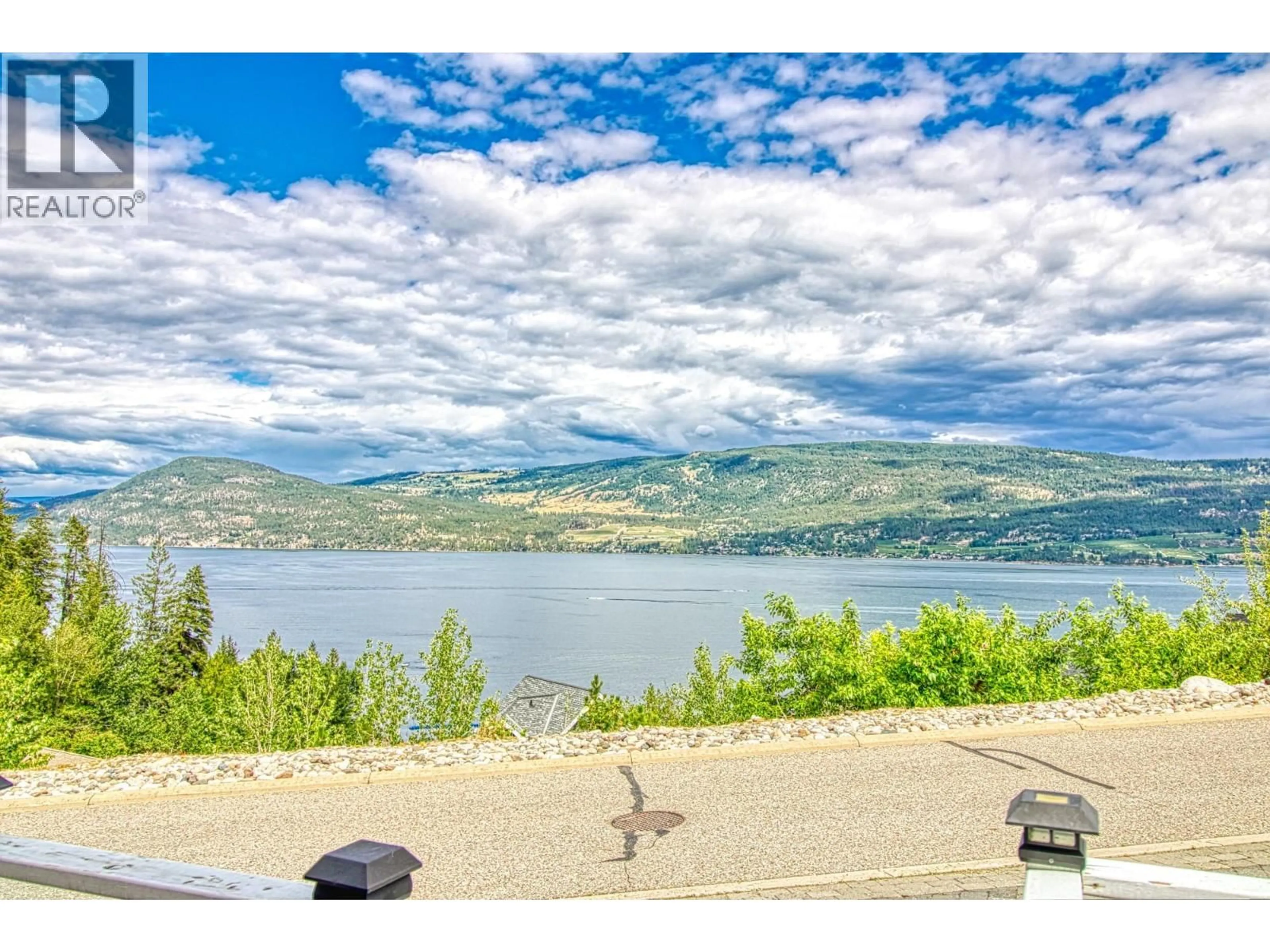 A pic from outside/outdoor area/front of a property/back of a property/a pic from drone, water/lake/river/ocean view for 121 - 6859 SANTIAGO LOOP, Kelowna British Columbia V1Z3R8