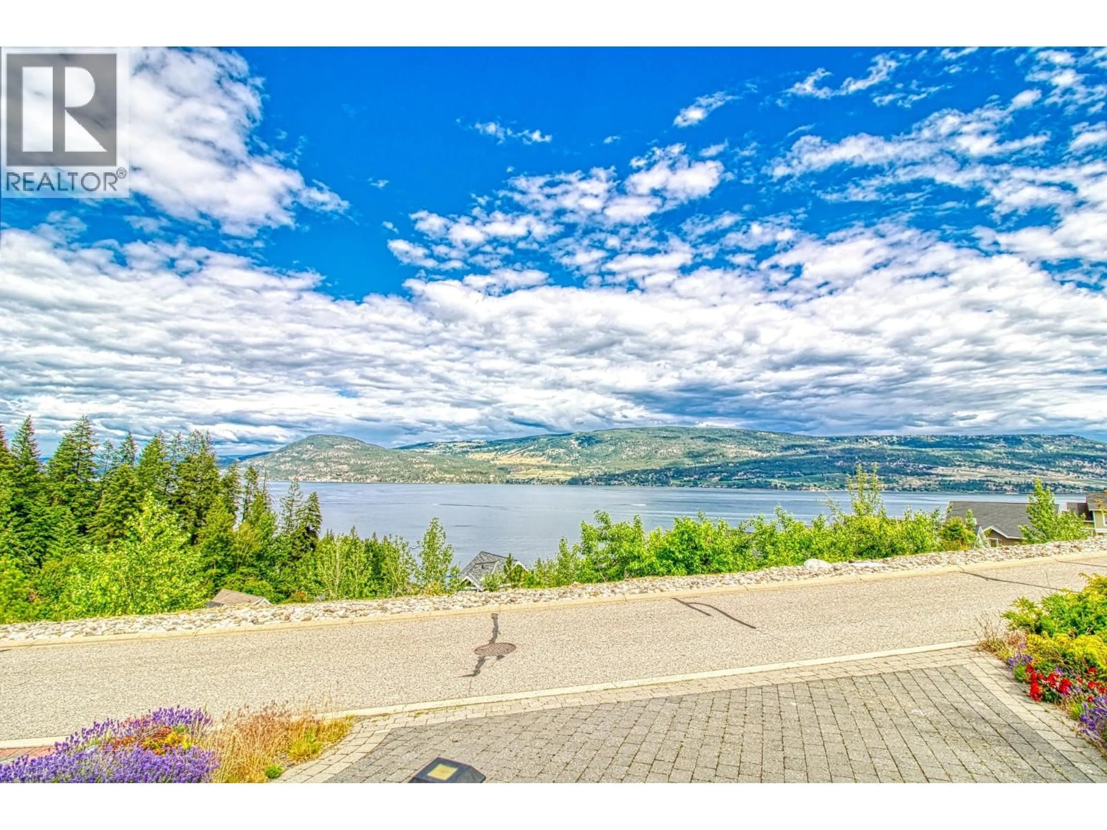 A pic from outside/outdoor area/front of a property/back of a property/a pic from drone, water/lake/river/ocean view for 121 - 6859 SANTIAGO LOOP, Kelowna British Columbia V1Z3R8