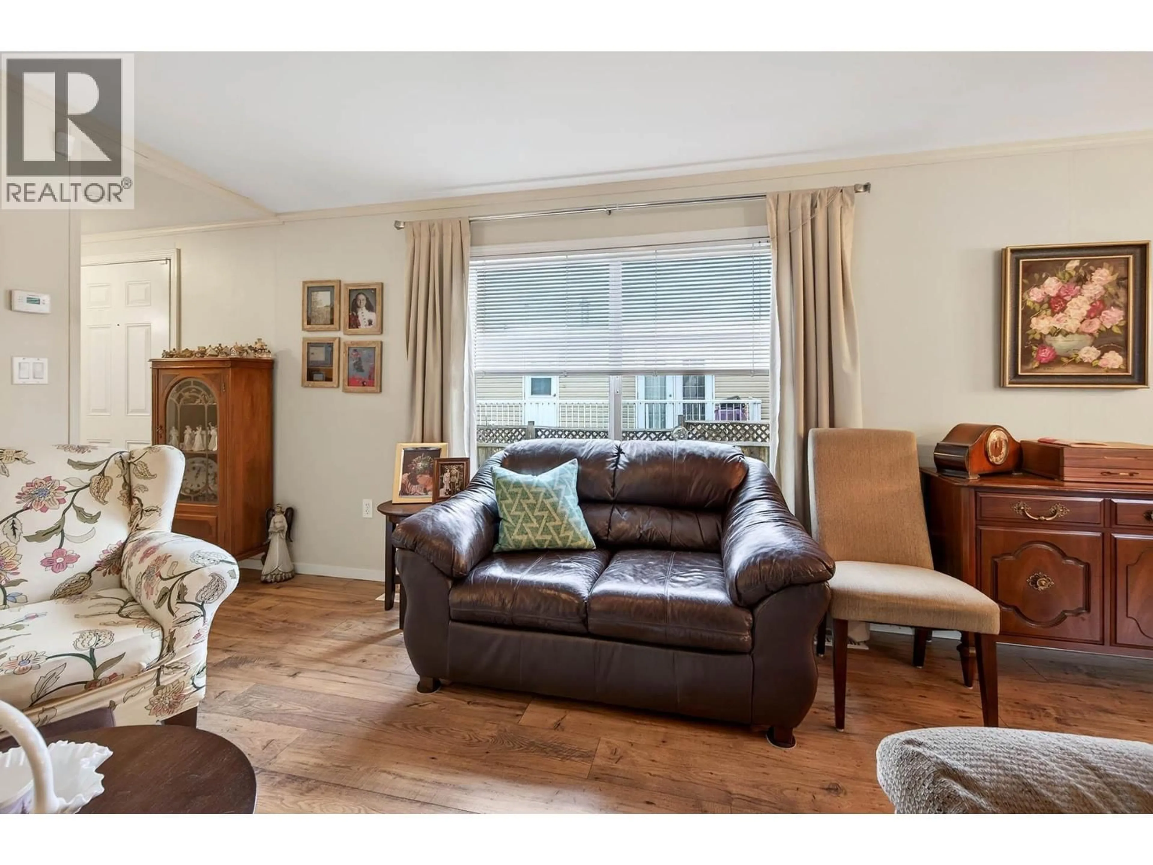 Living room with furniture, wood/laminate floor for 80 - 7545 DALLAS DRIVE, Kamloops British Columbia V2C6X9