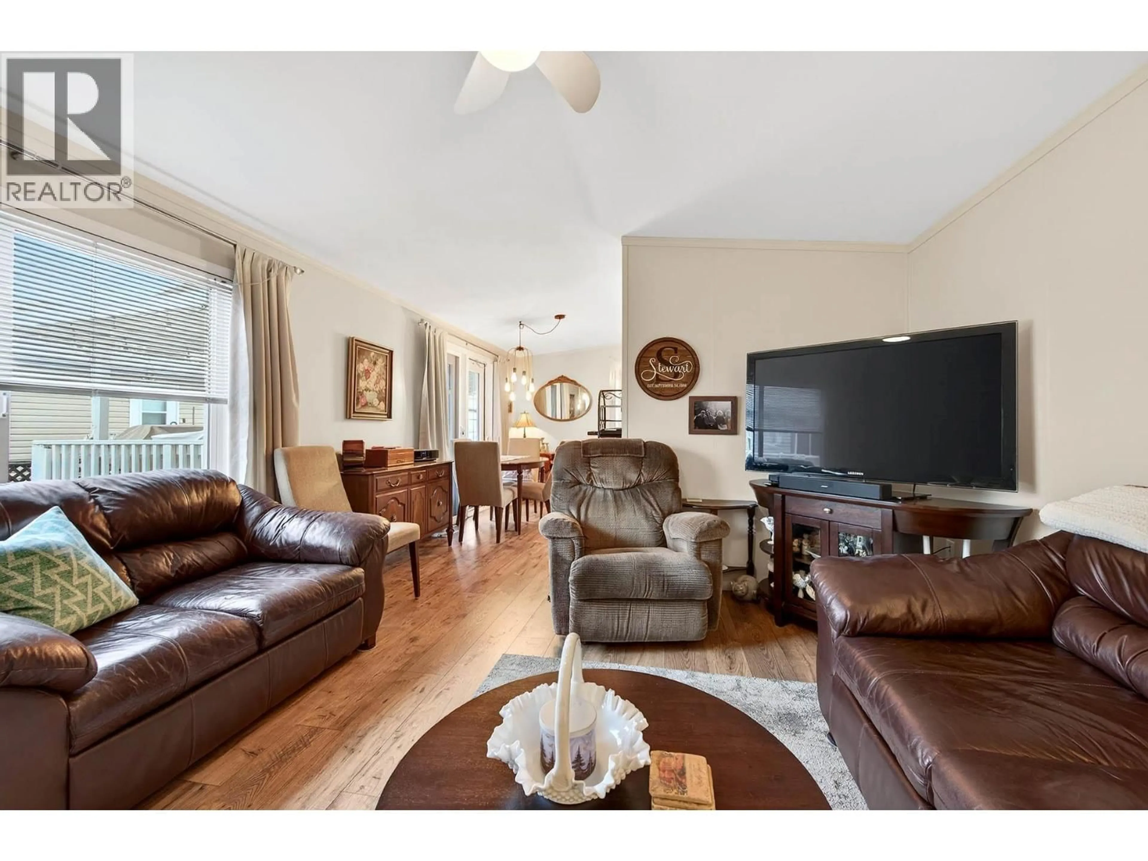 Living room with furniture, wood/laminate floor for 80 - 7545 DALLAS DRIVE, Kamloops British Columbia V2C6X9