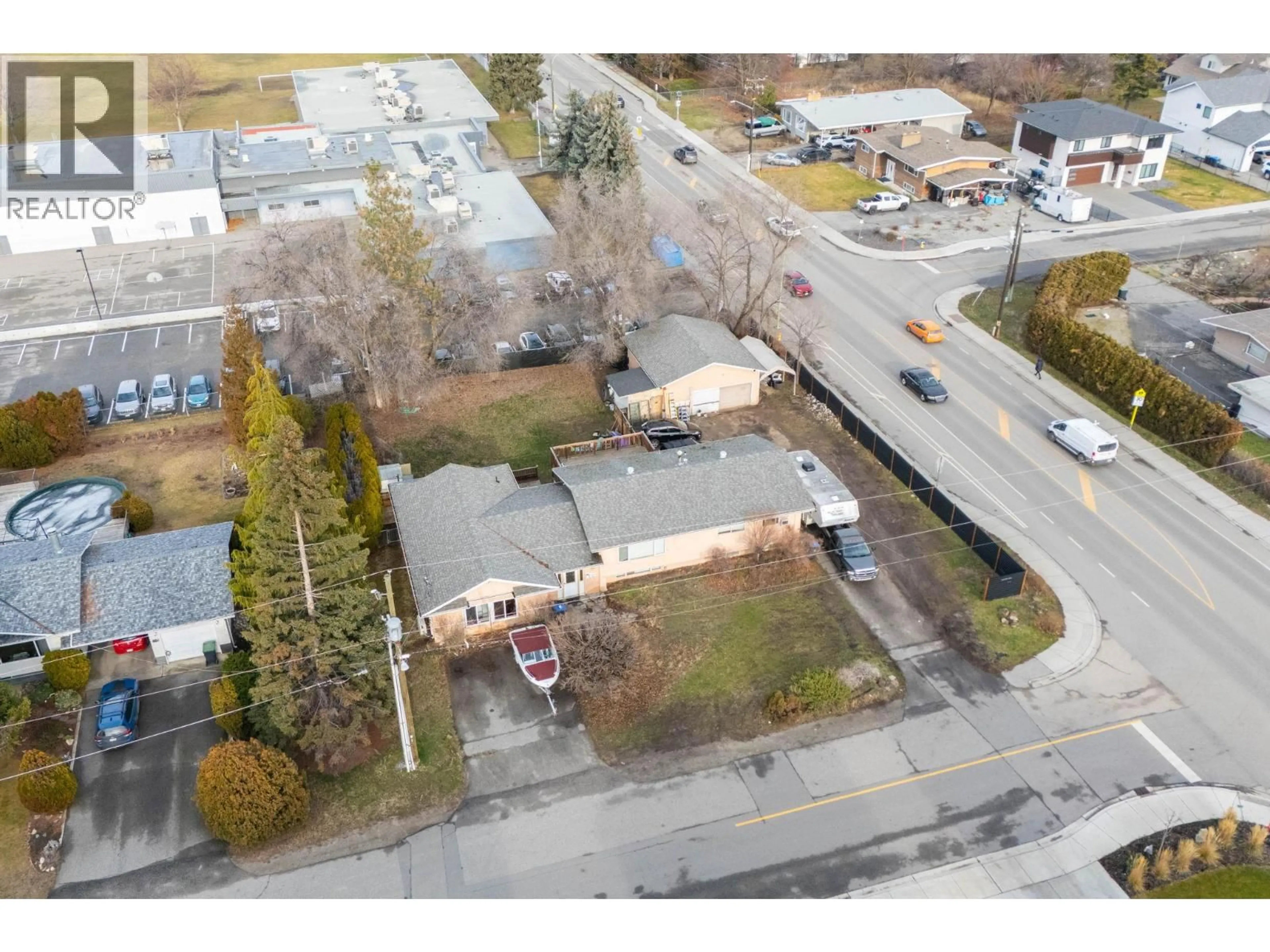 A pic from outside/outdoor area/front of a property/back of a property/a pic from drone, street for 698 BALSAM ROAD, Kelowna British Columbia V1W1B9