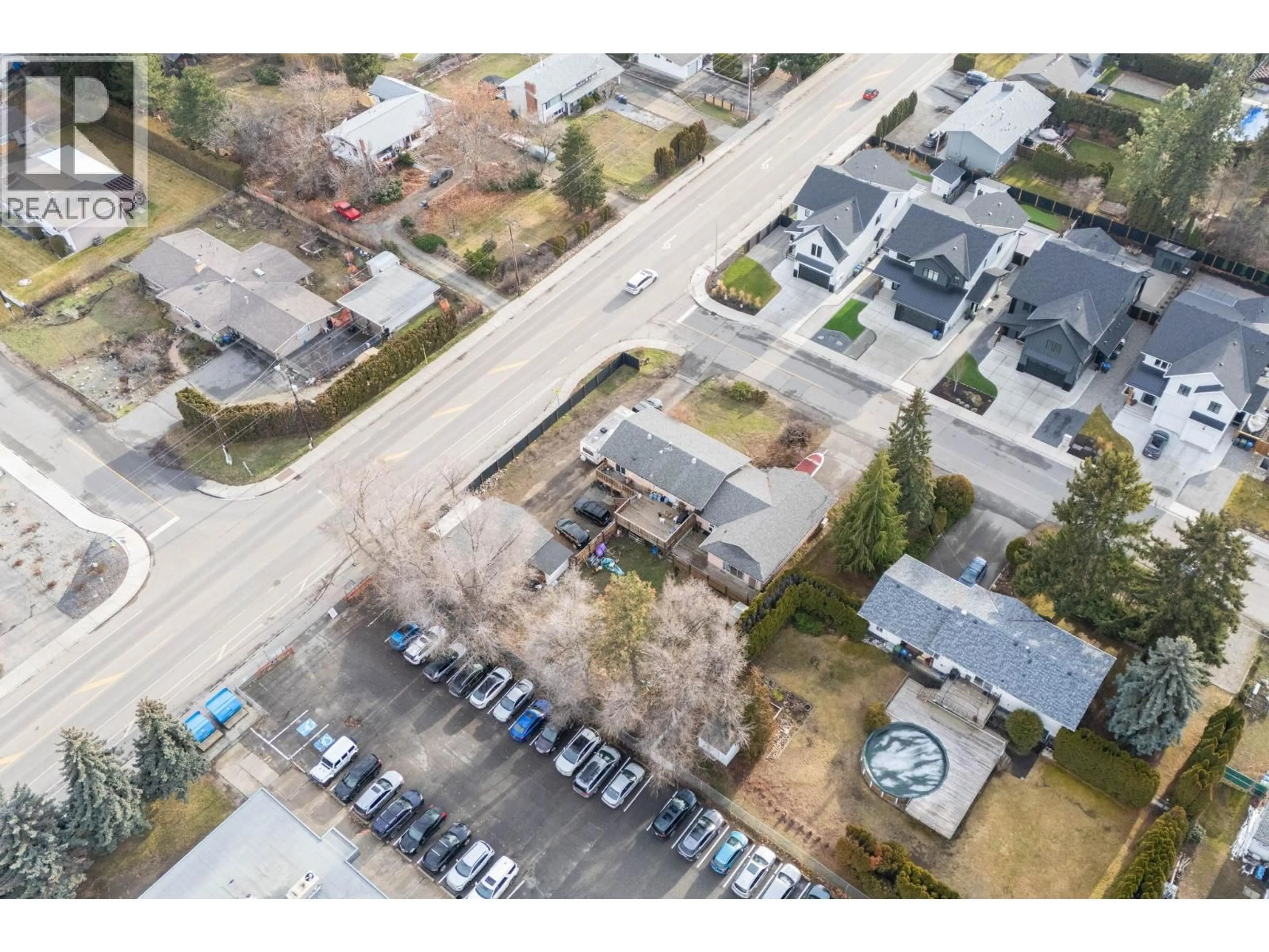 A pic from outside/outdoor area/front of a property/back of a property/a pic from drone, street for 698 BALSAM ROAD, Kelowna British Columbia V1W1B9