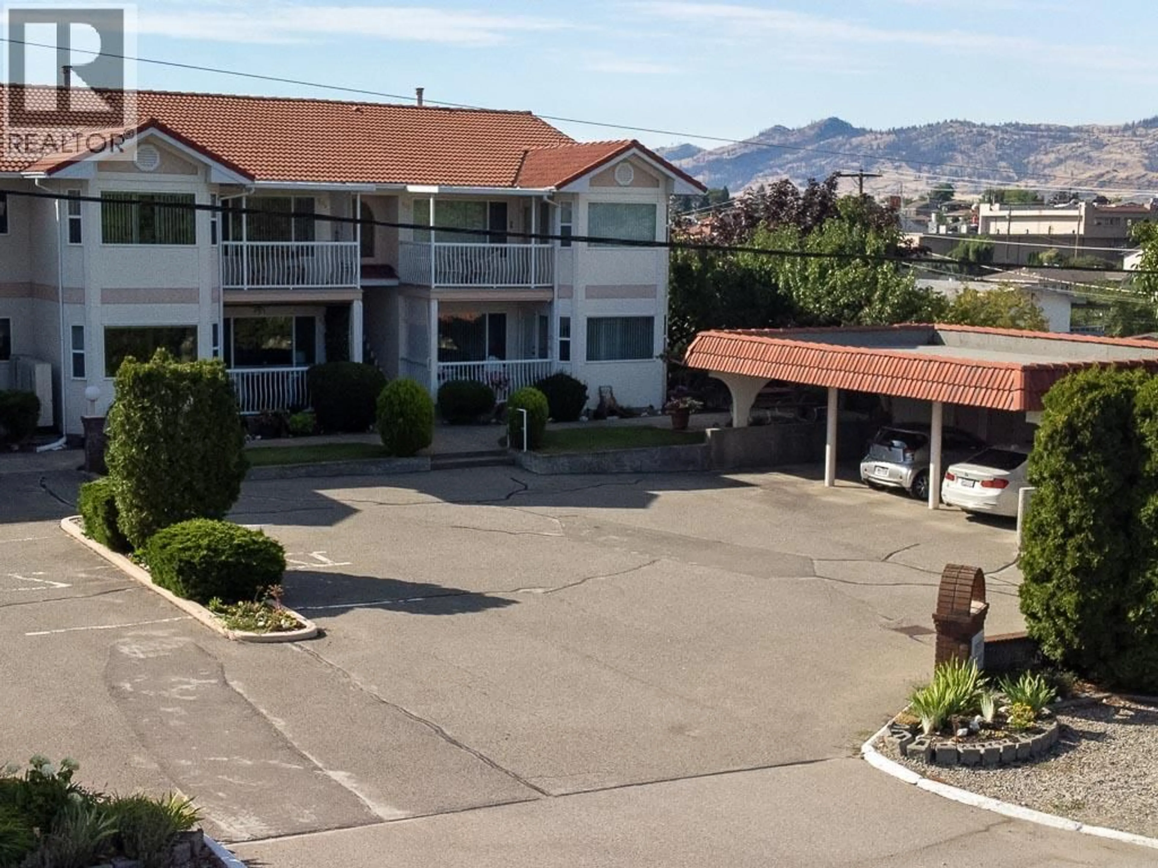 A pic from outside/outdoor area/front of a property/back of a property/a pic from drone, mountain view for 104 - 8911 92ND AVENUE, Osoyoos British Columbia V0H1V2