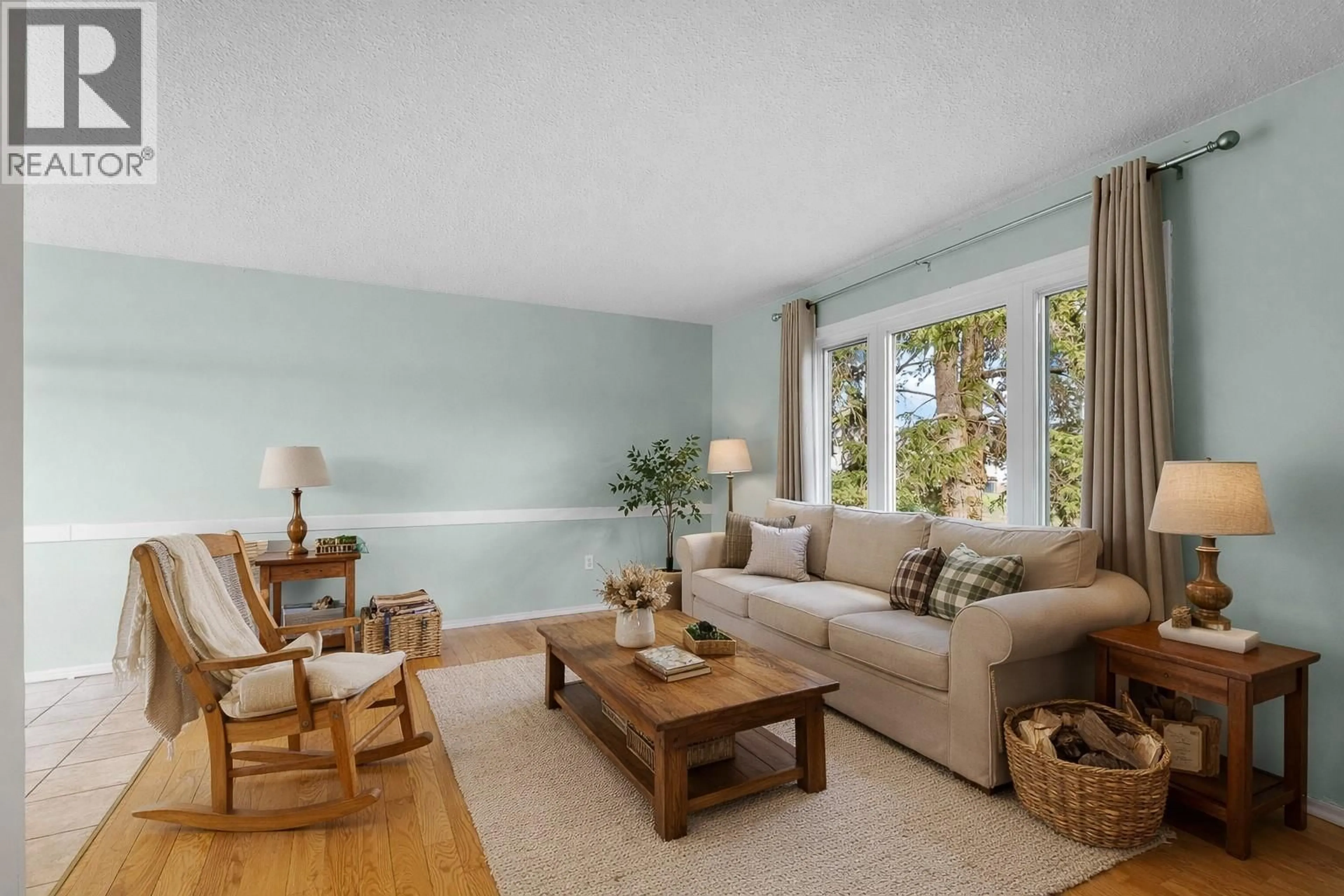 Living room with furniture, wood/laminate floor for 1799 ARMSTRONG STREET, Merritt British Columbia V1K1E7